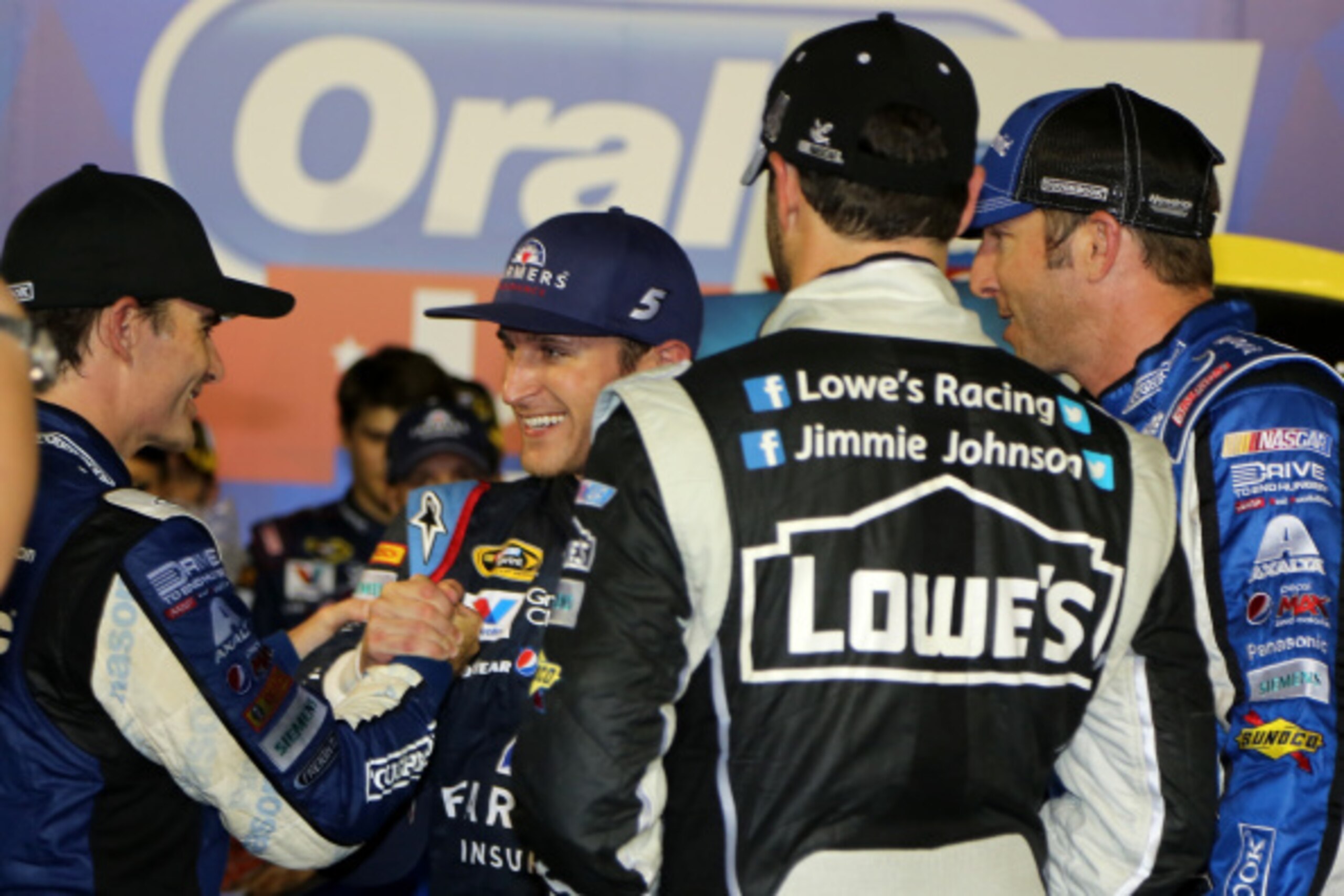 HAMPTON, GA - AUGUST 31: (L-R) Jeff Gordon, driver of the #24 Panasonic Chevrolet, Jimmie Johnson, driver of the #48 Lowe's/Kobalt Tools Chevrolet, and his crew chief, Chad Knaus, congratulate Kasey Kahne (M), driver of the #5 Farmers Insurance Chevrolet,