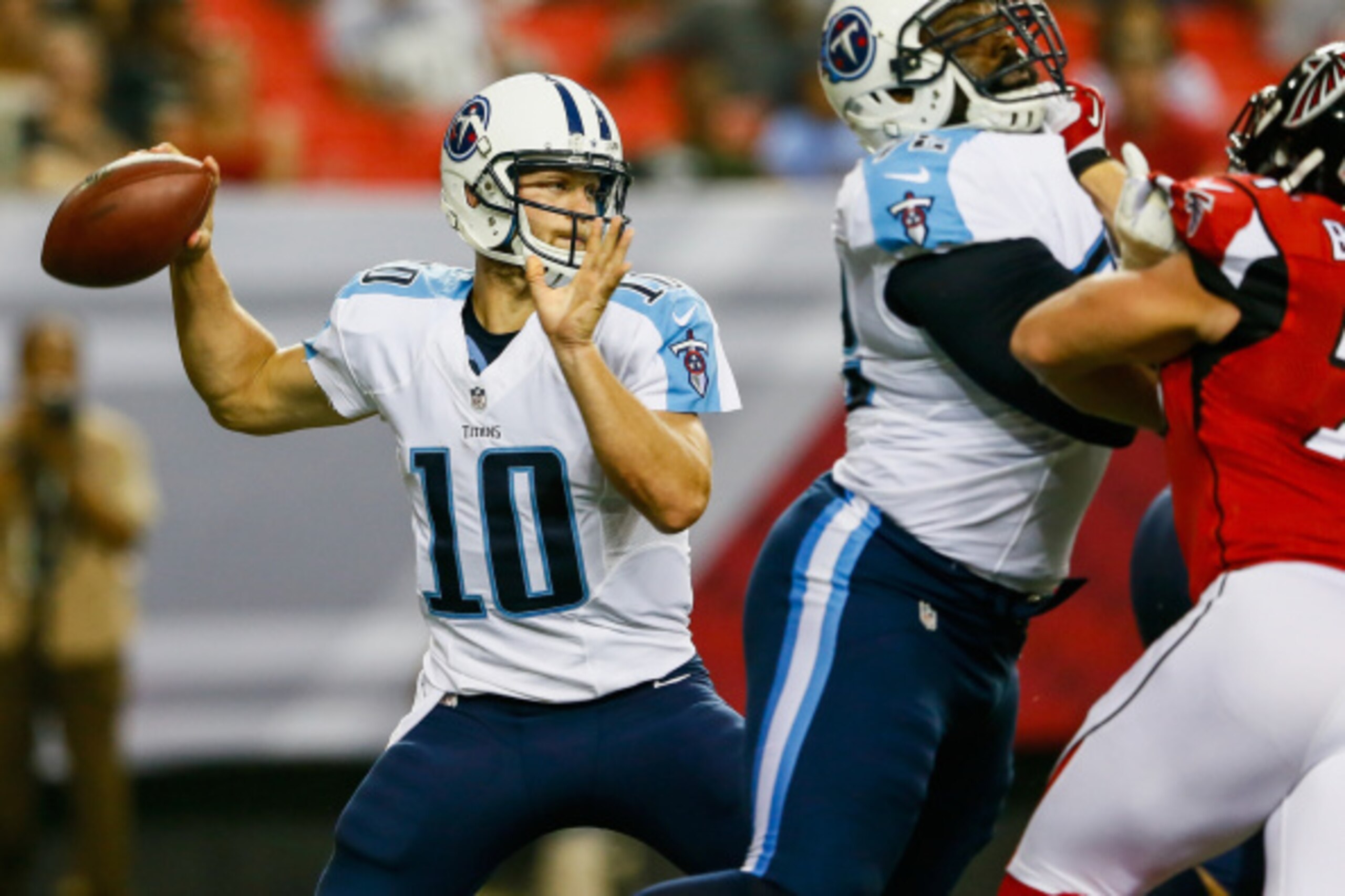 ATLANTA, GA - AUGUST 23:  Jake Locker #10 of the Tennessee Titans drops back to pass in the first half of a preseason game against the Atlanta Falcons at the Georgia Dome on August 23, 2014 in Atlanta, Georgia.  (Photo by Kevin C. Cox/Getty Images)
