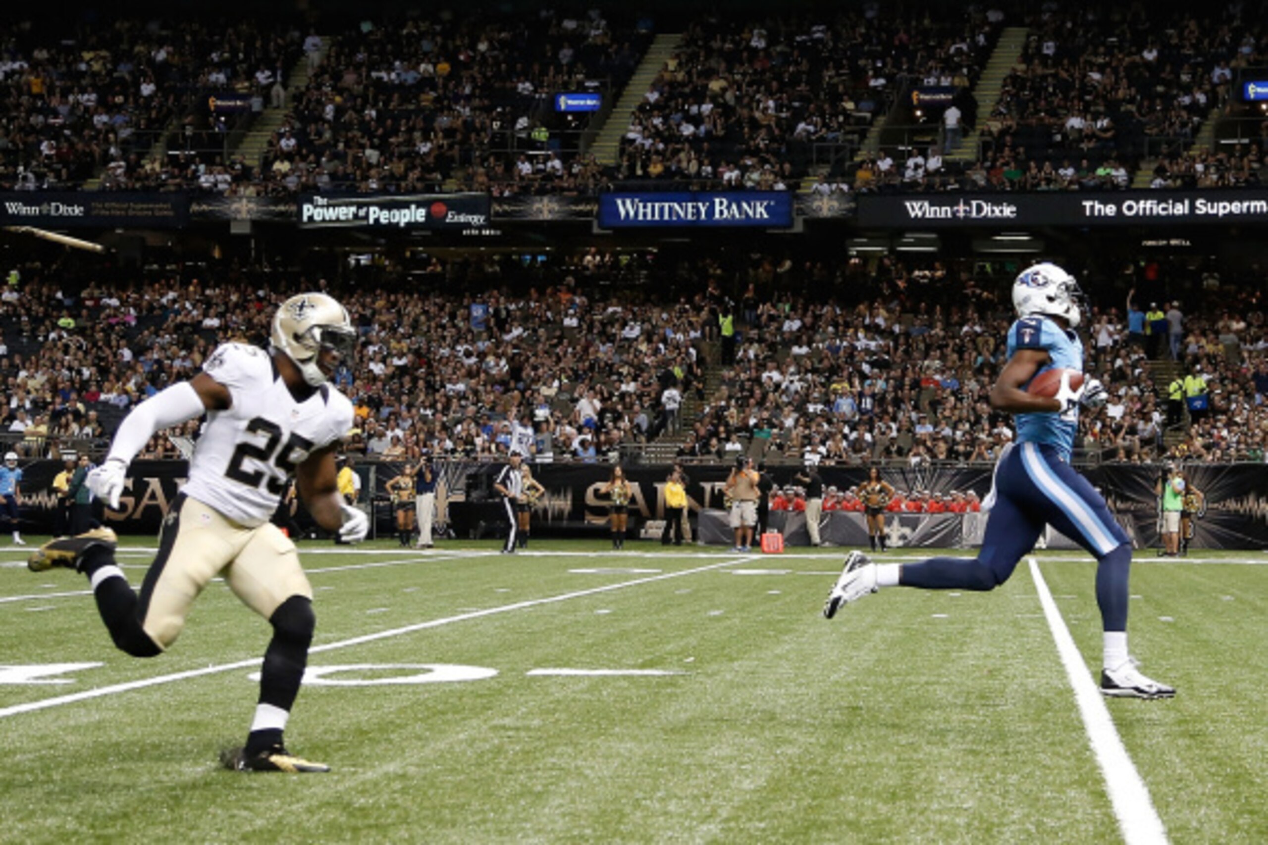 NEW ORLEANS, LA - AUGUST 15:  Justin Hunter #15 of the Tennessee Titans runs in a pass for a touchdown in front of Rafael Bush #25 of the New Orleans Saints during a preseason game at the Mercedes-Benz Superdome on August 15, 2014 in New Orleans, Louisian