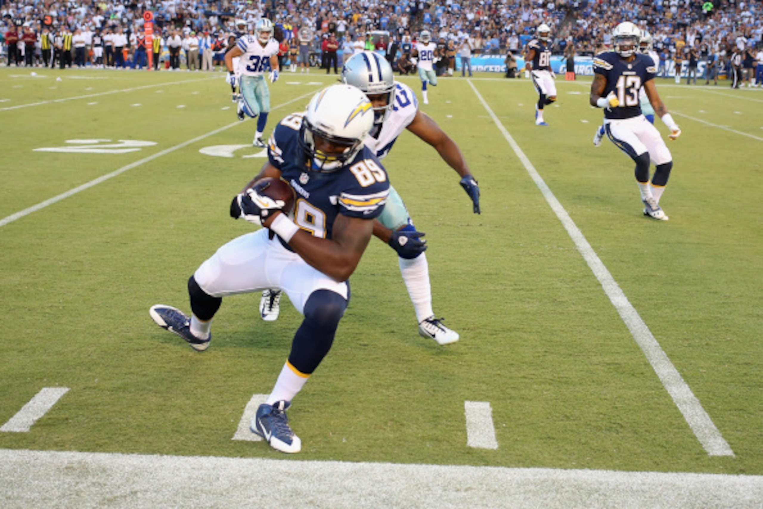 SAN DIEGO, CA - AUGUST 07:  Ladarius Green #89 of the San Diego Chargers is pushed out of bounds by J.J. Wilcox #27 of the Dallas Cowboys during a preseason game at Qualcomm Stadium on August 7, 2014 in San Diego, California.  (Photo by Stephen Dunn/Getty