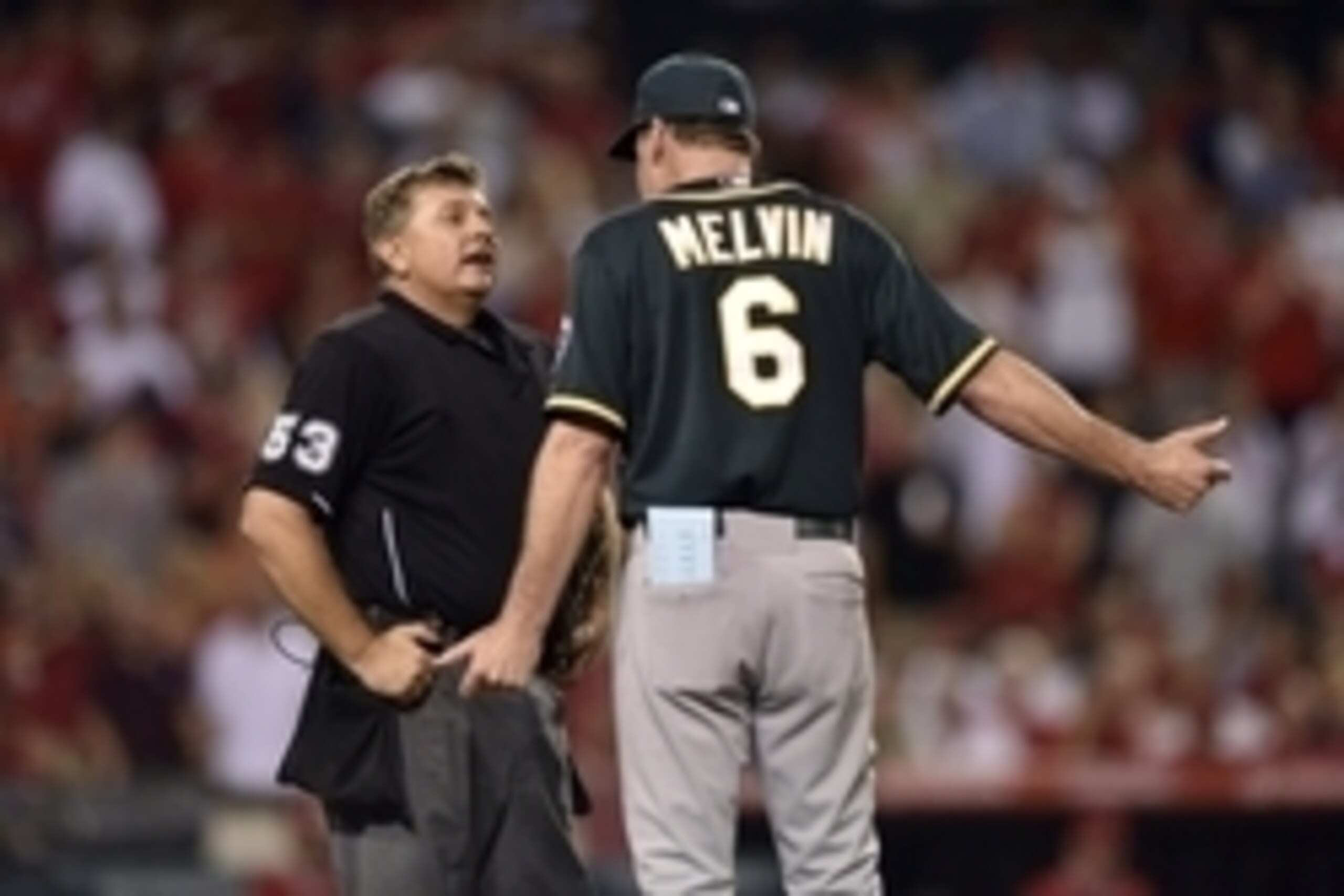 Aug 28, 2014; Anaheim, CA, USA; Oakland Athletics manager Bob Melvin talks with home plate umpire Greg Gibson after Los Angeles Angels shortstop Erick Aybar (not pictured) is called safe at first after a collision during the ninth inning at Angel Stadium 