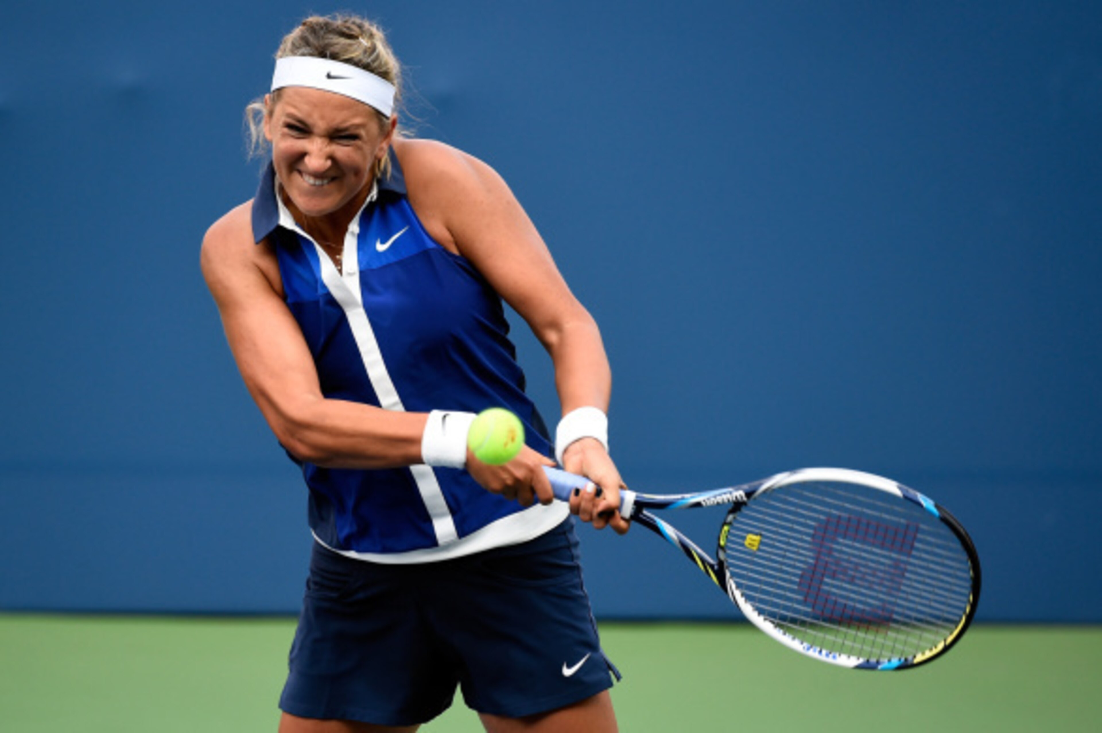 NEW YORK, NY - AUGUST 26:  Victoria Azarenka of Belarus returns a shot against Misaki Doi of Japan during their women's singles first round match on Day Two of the 2014 US Open at the USTA Billie Jean King National Tennis Center on August 26, 2014  in the