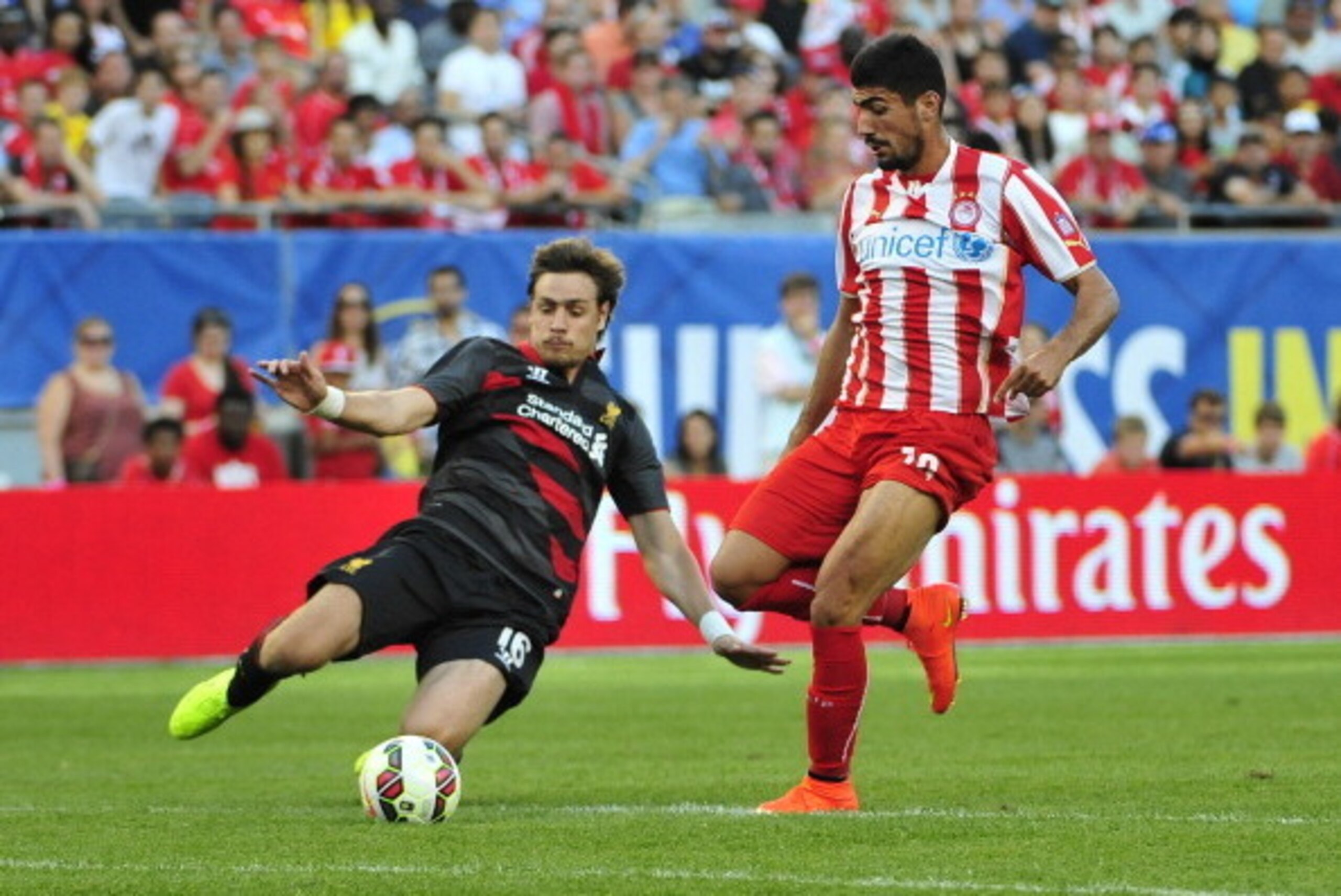 CHICAGO, IL - JULY 27: Andreas Bouchalakis #18 of Olympiacos FC is defended by Sebastian Coates #16 of Liverpool in the second half during the International Champions Cup 2014 on July 27, 2014 at Soldier Field in Chicago, Illinois. Liverpool defeated Olym