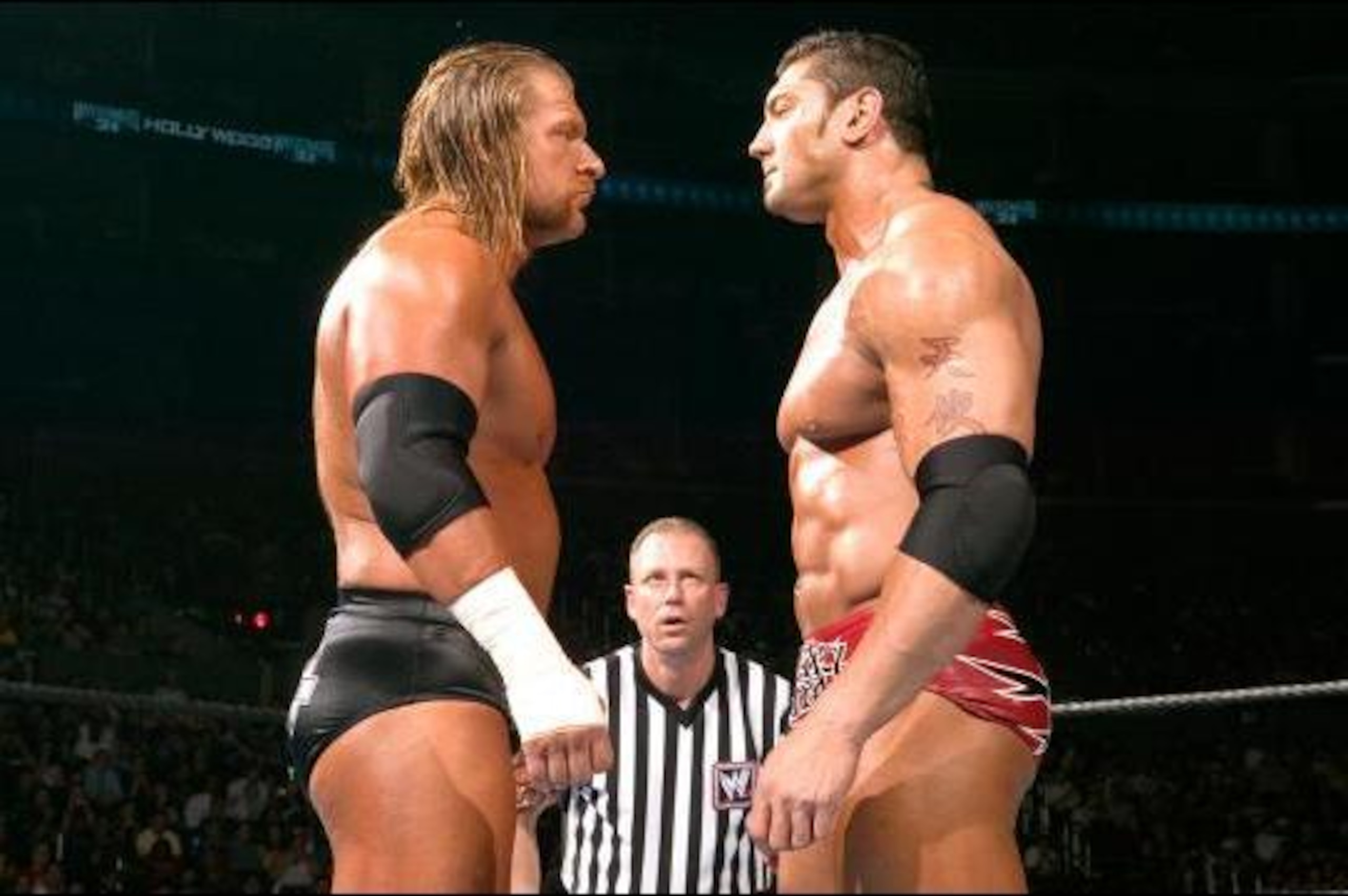Triple H and Batista stare each other down at WrestleMania 21.