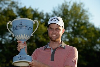 NORTON, MA - SEPTEMBER 01:  Chris Kirk is presented with the winner's trophy after winning the Deutsche Bank Championship at the TPC Boston on September 1, 2014 in Norton, Massachusetts.  (Photo by Ross Kinnaird/Getty Images)