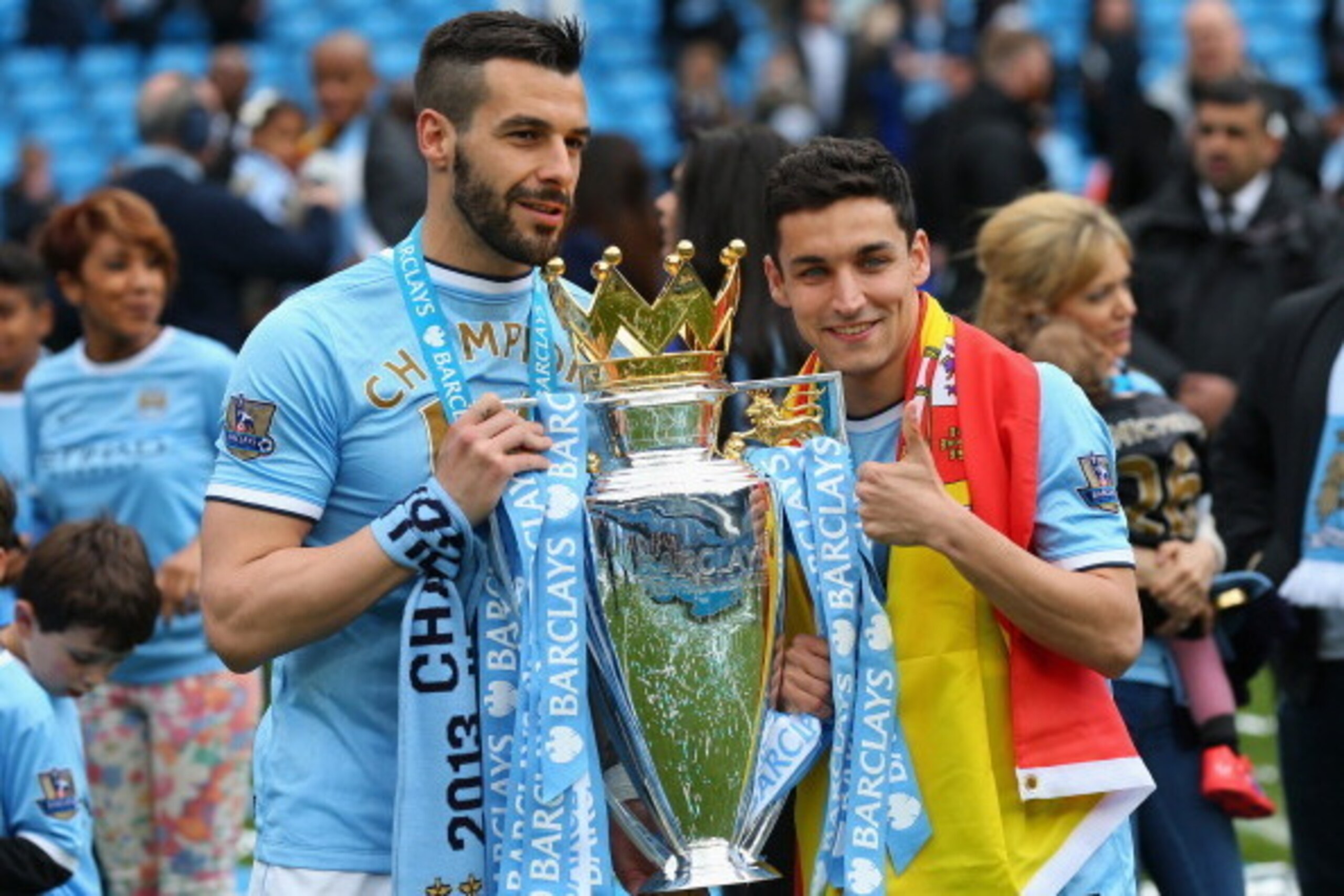 MANCHESTER, ENGLAND - MAY 11:  Alvaro Negredo of Manchester City and Jesus Navas (R) pose with the trophy at the end of the Barclays Premier League match between Manchester City and West Ham United at the Etihad Stadium on May 11, 2014 in Manchester, Engl