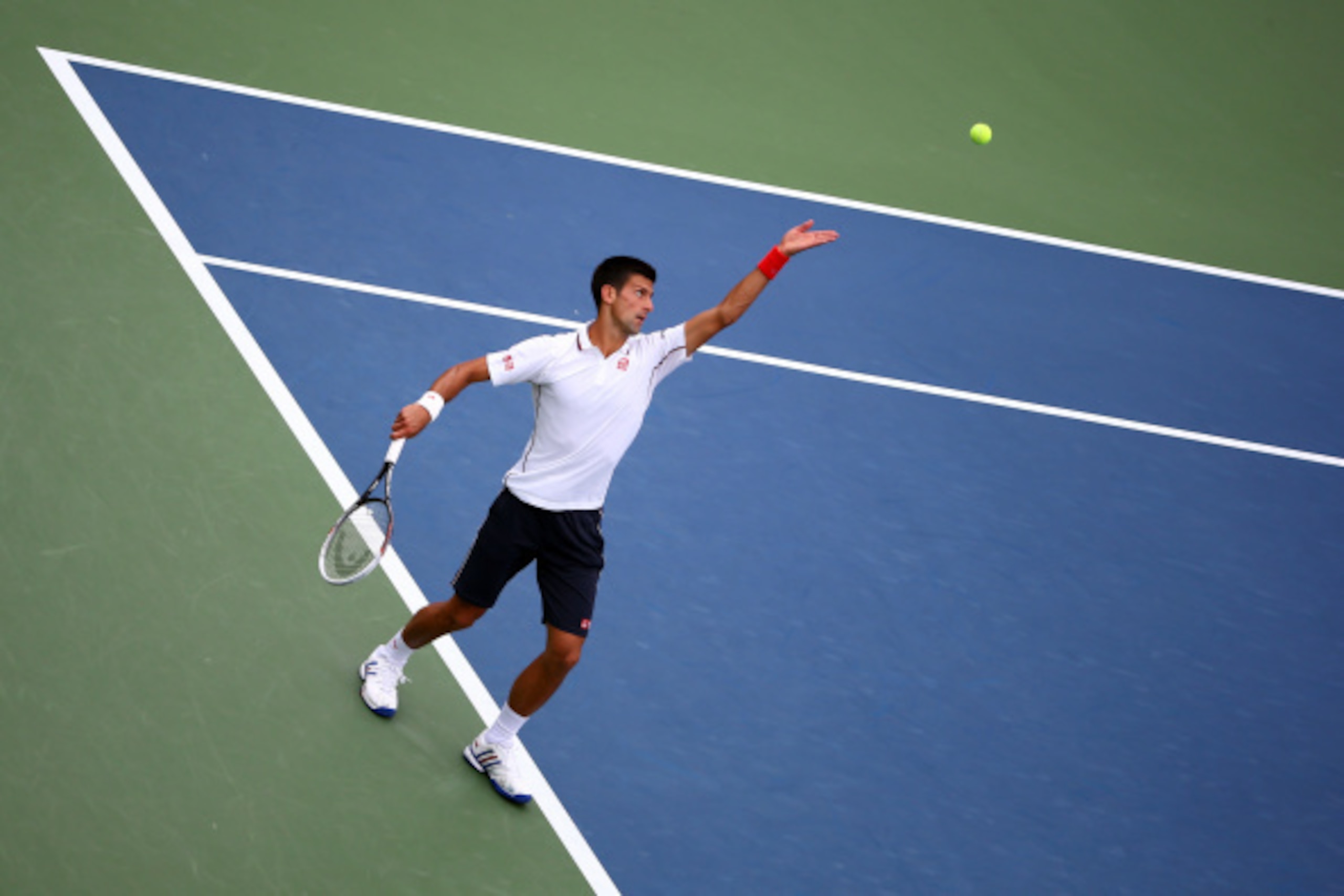 NEW YORK, NY - AUGUST 30:  Novak Djokovic of Serbia serves to Sam Querrey of the United States during their men's singles third round match on Day Six of the 2014 US Open at the USTA Billie Jean King National Tennis Center on August 30, 2014 in the Flushi