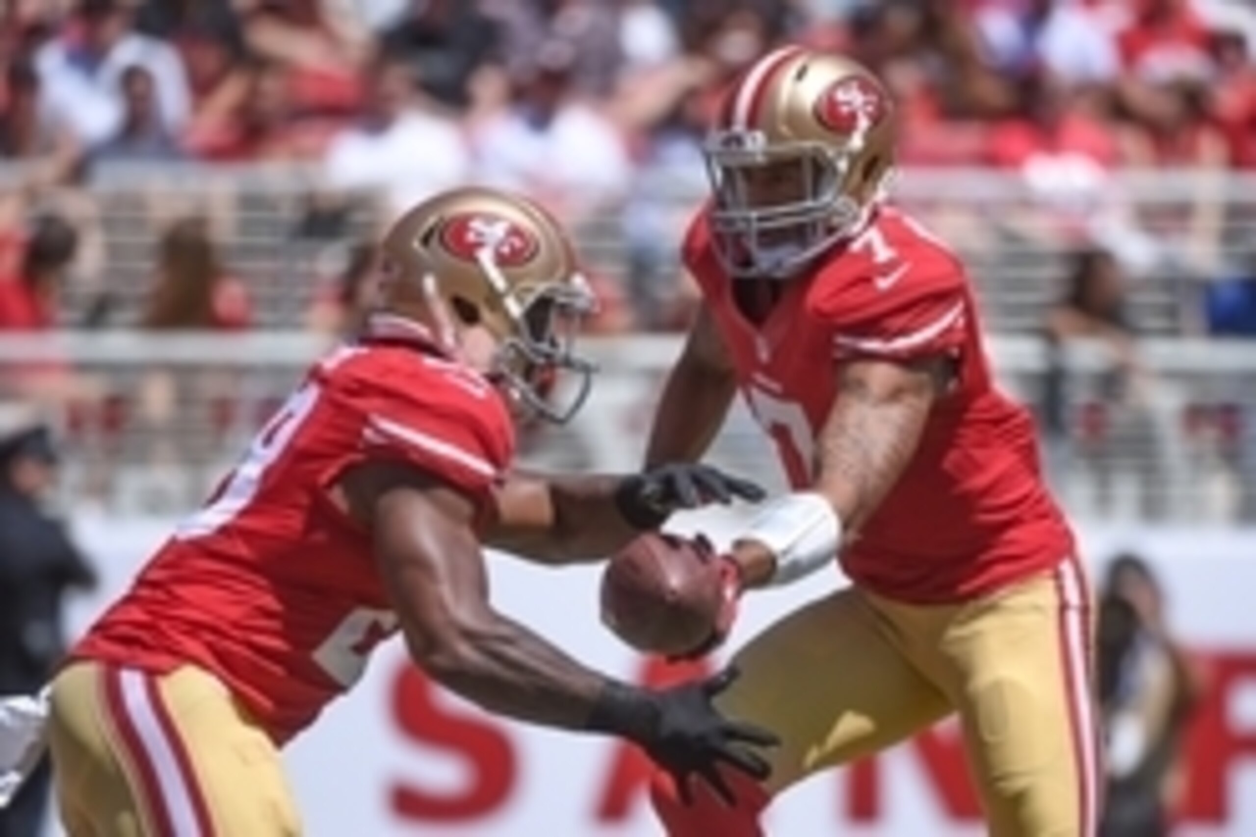 August 24, 2014; Santa Clara, CA, USA; San Francisco 49ers quarterback Colin Kaepernick (7) hands the football off to running back Carlos Hyde (28) during the first quarter  against the San Diego Chargers at Levi's Stadium. The 49ers defeated the Chargers