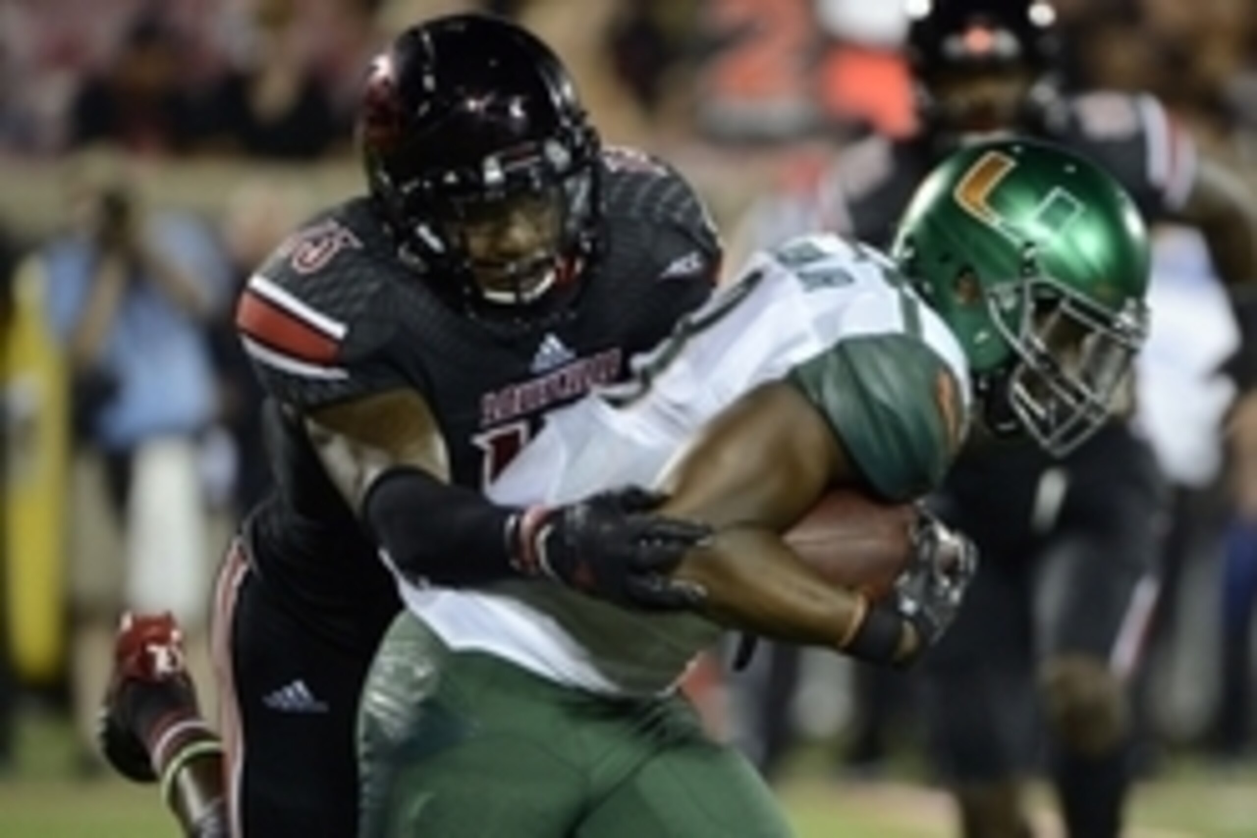 Sep 1, 2014; Louisville, KY, USA; Louisville Cardinals linebacker James Burgess (13) tackles Miami Hurricanes running back Duke Johnson (8) during the second half of play at Papa John's Cardinal Stadium. Louisville defeated Miami 31-13.  Mandatory Credit: