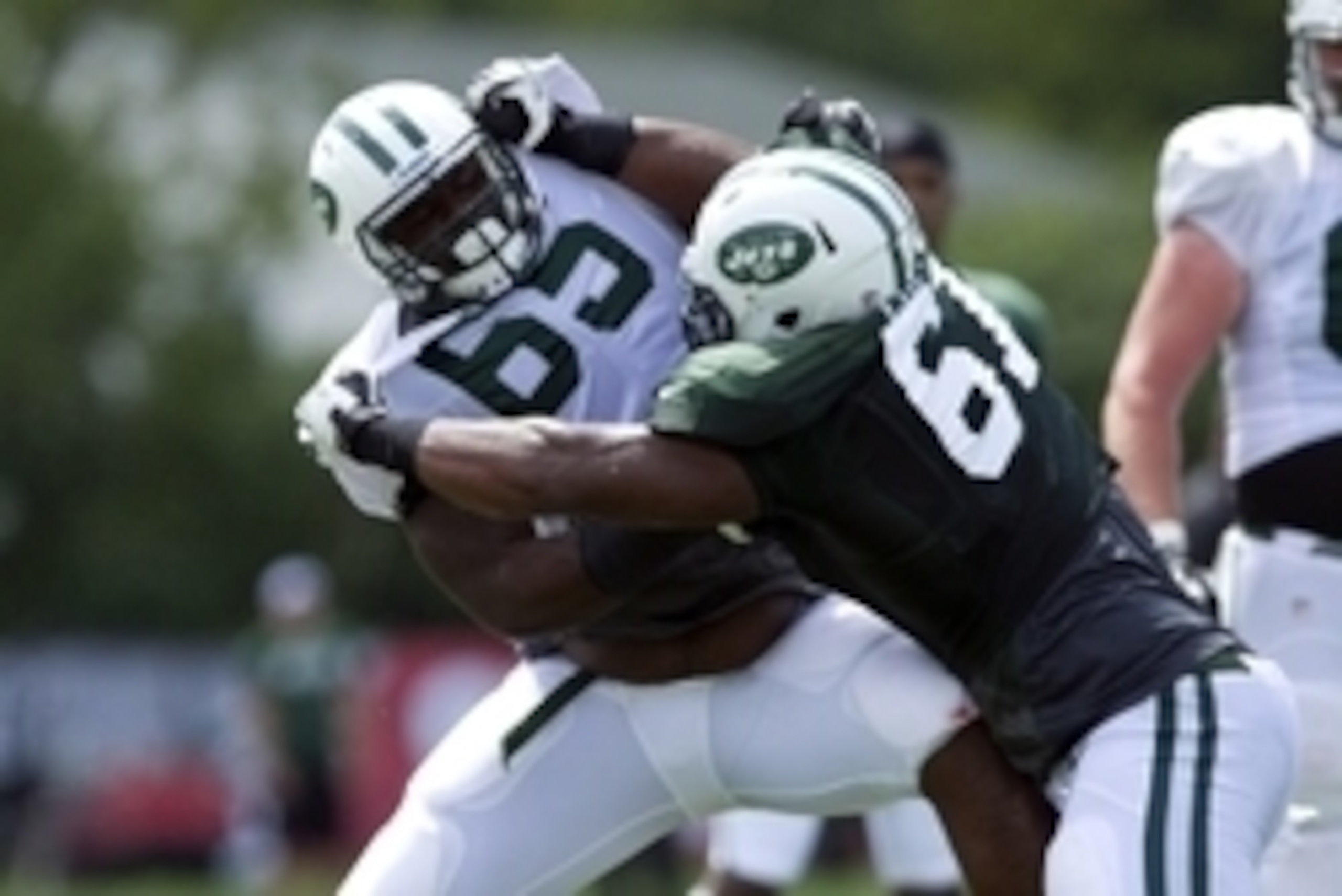Jul 31, 2013; Cortland, NY, USA; New York Jets guard William Campbell (65) and tackle Lanier Coleman (61) wrestle during training camp at SUNY Cortland.  Mandatory Credit: Rich Barnes-USA TODAY Sports
