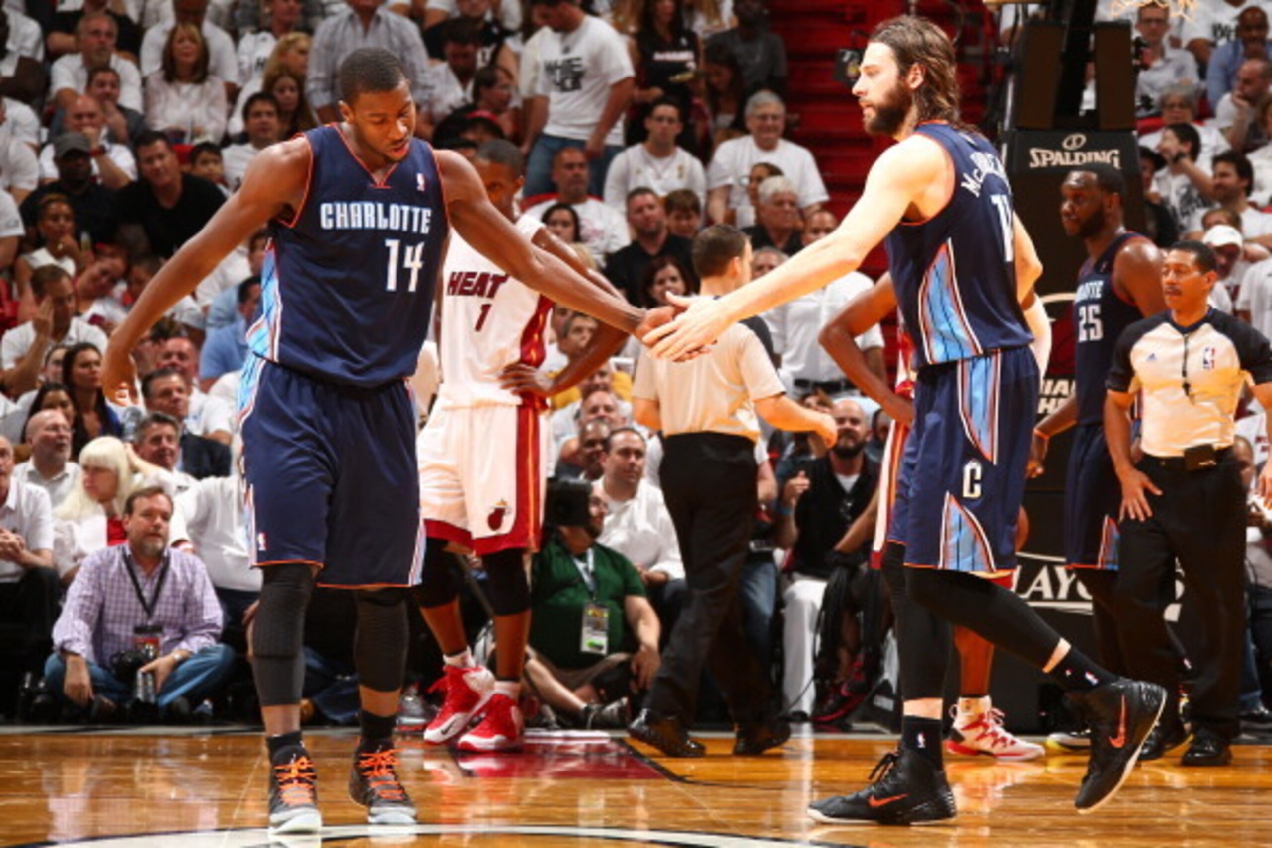 MIAMI, FL - APRIL 23:  Michael Kidd-Gilchrist #14 and Josh McRoberts #11 of the Charlotte Bobcats slap hands against the Miami Heat in Game Two of the Eastern Conference Quarterfinals of the 2014 NBA playoffs at American Airlines Arena in Miami, Florida o