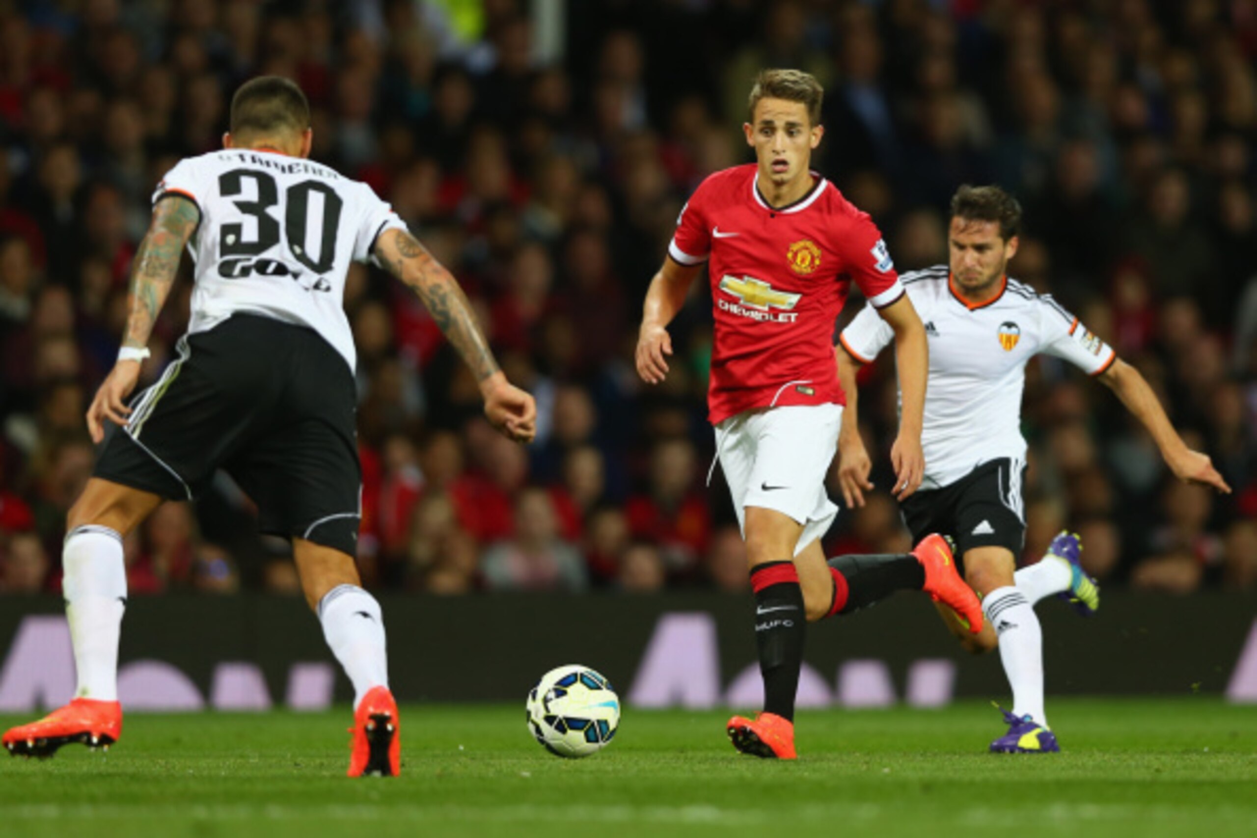 MANCHESTER, ENGLAND - AUGUST 12:  Adnan Januzaj of Manchester United attempts to move past Nicolas Otamendi of Valencia during the Pre Season Friendly match between Manchester United and Valencia at Old Trafford on August 12, 2014 in Manchester, England. 