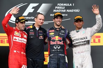 BUDAPEST, HUNGARY - JULY 27:  Daniel Ricciardo of Australia and Infiniti Red Bull Racing celebrates victory on the podium next Fernando Alonso of Spain and Ferrari and Lewis Hamilton of Great Britain and Mercedes GP after the Hungarian Formula One Grand P