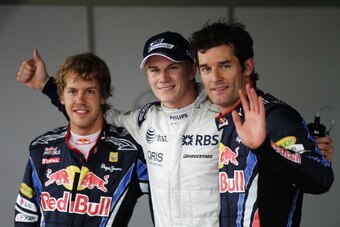 SAO PAULO, BRAZIL - NOVEMBER 06:  Pole sitter Nico Huelkenberg (C) of Germany and Williams celebrates in parc ferme with second placed Sebastian Vettel (L) of Germany and Red Bull Racing and third placed Mark Webber (R) of Australia and Red Bull Racing fo
