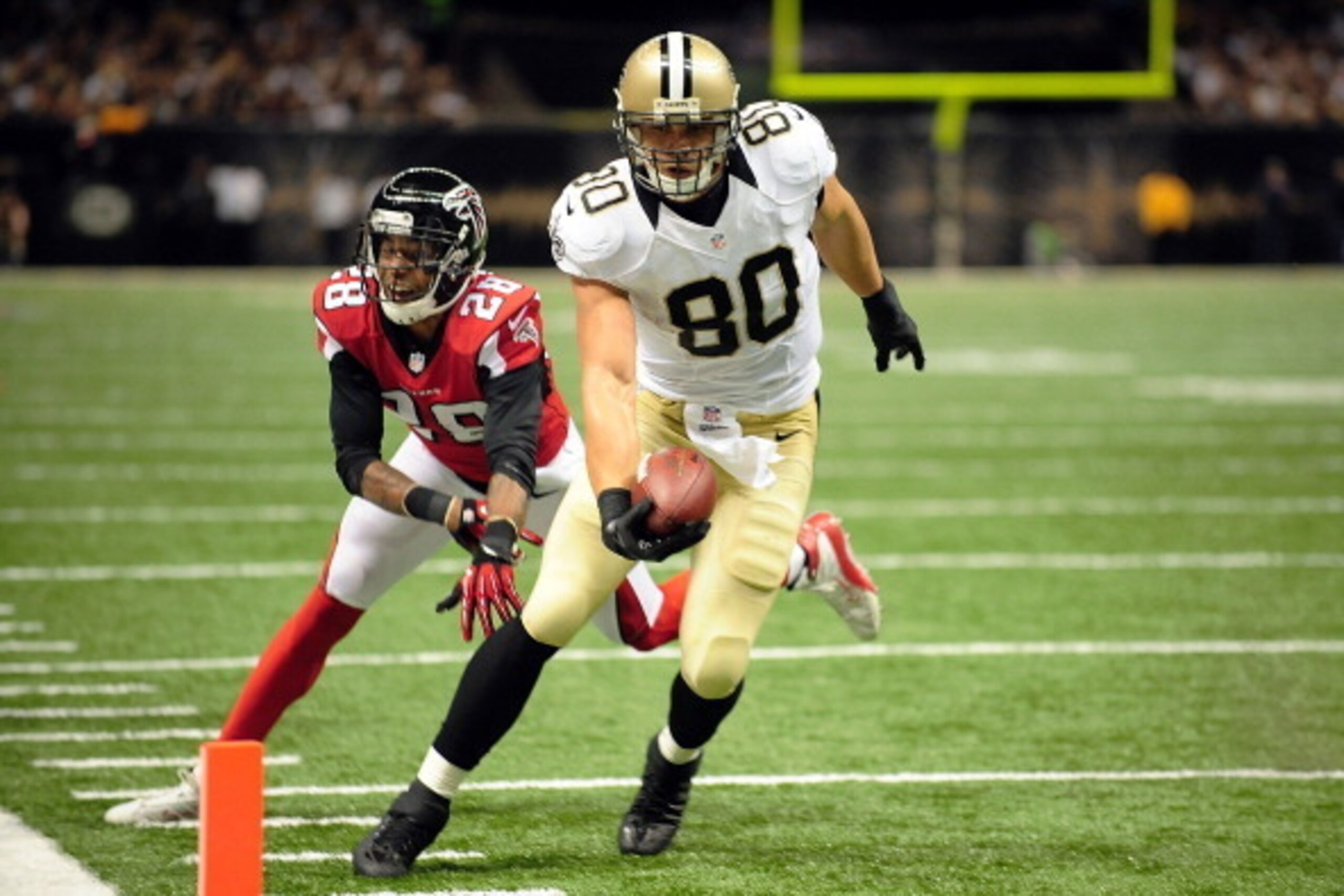 NEW ORLEANS, LA - SEPTEMBER 08: Jimmy Graham #80 of the New Orleans Saints scores a touchdown in front of Thomas DeCoud #28 of the Atlanta Falcons during a game at the Mercedes-Benz Superdome on September 8, 2013 in New Orleans, Louisiana. The Saints defe