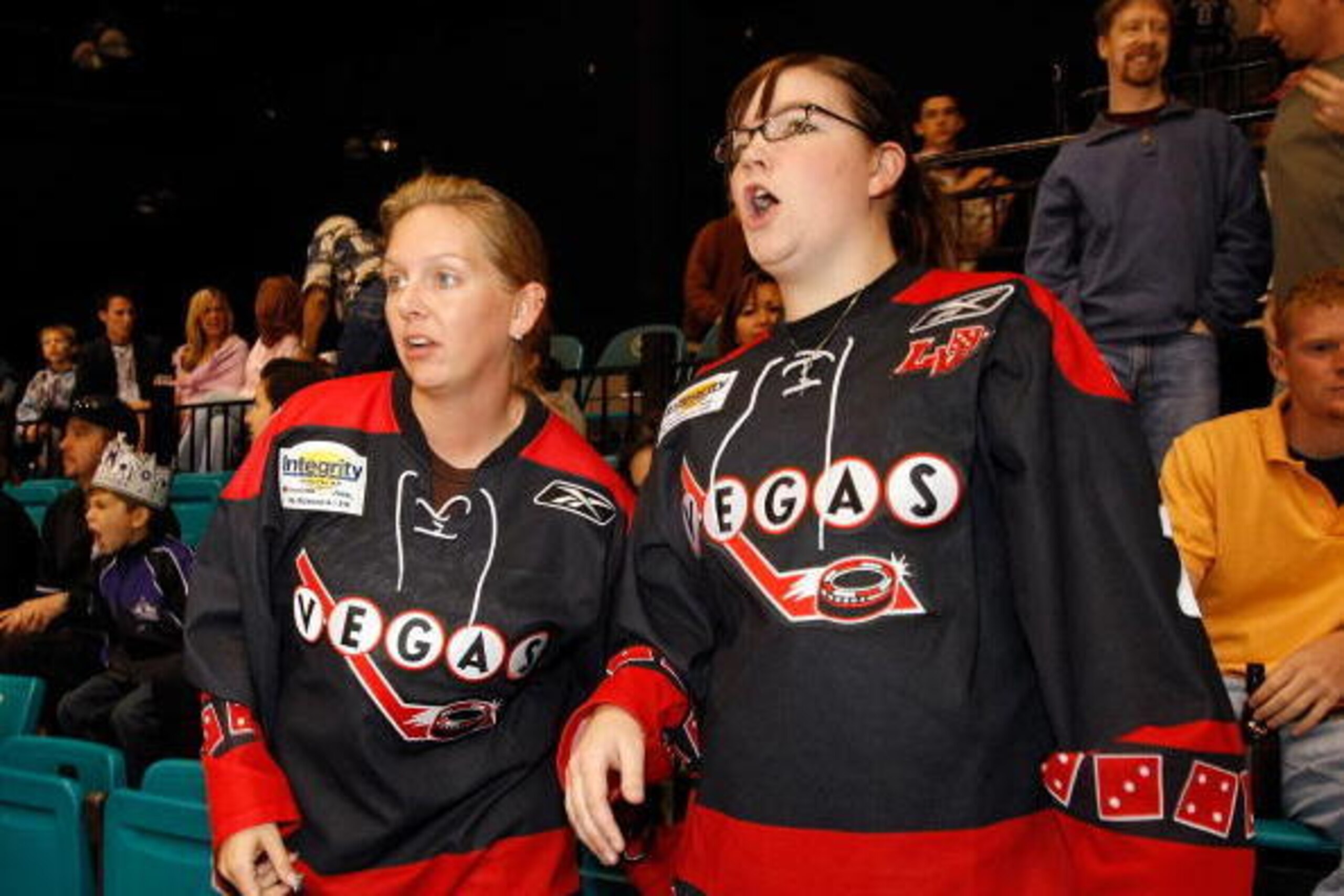 LAS VEGAS - SEPTEMBER 27:  Kristel Torvik (L) and Erin Mahoney, both of Nevada, wear jerseys from the ECHL Las Vegas Wranglers as they watch the Colorado Avalanche take on the Los Angeles Kings in a preseason game at the MGM Grand Garden Arena September 2