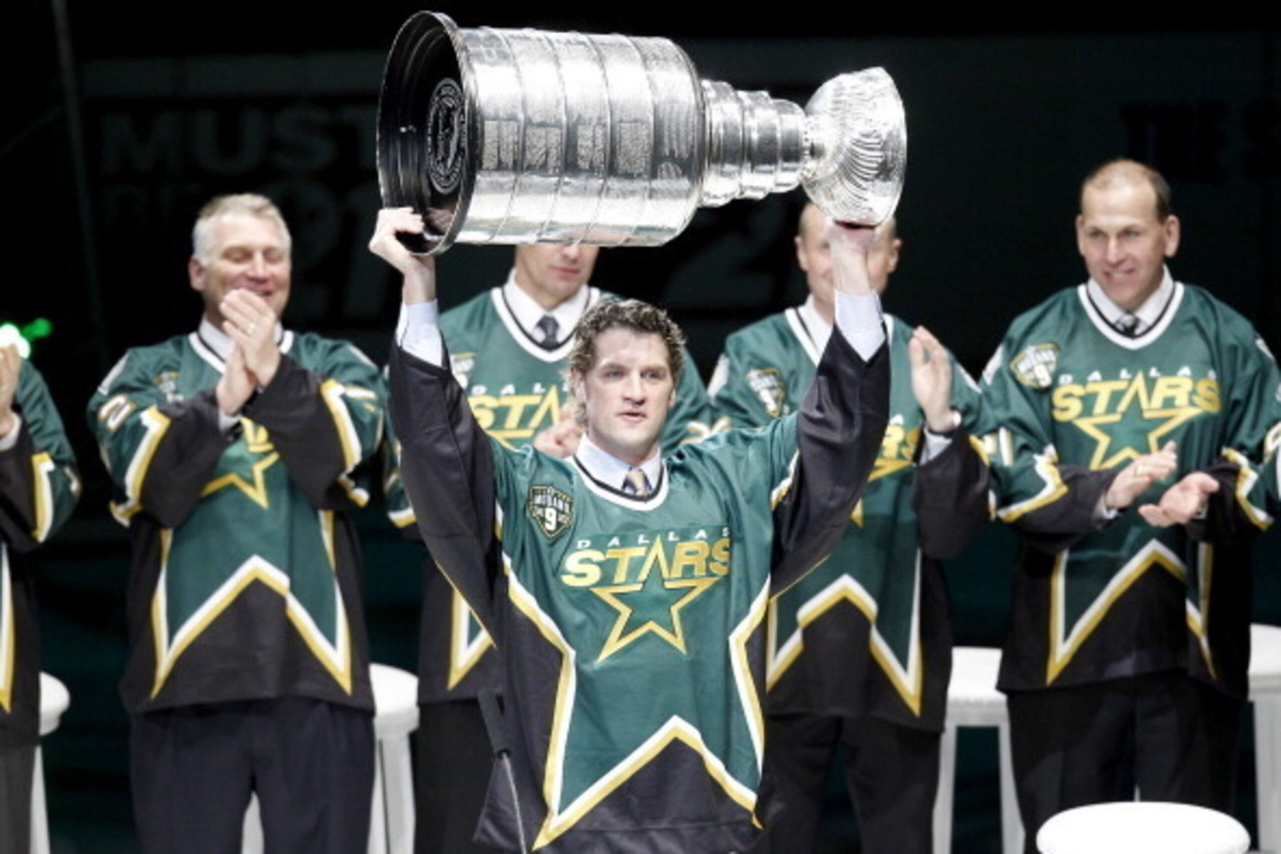 DALLAS, TX - MARCH 08: Former Dallas Star Derian Hatcher carries the Stanley Cup before Mike Modano has his jersey retired before the Dallas Stars play against the Minnesota Wild on March 8, 2014 at American Airlines Center in Dallas, Texas.(Photo by Thom