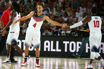 BILBAO, SPAIN - SEPTEMBER 2: Teammates Stephen Curry #4 and Kyrie Irving #10 of the USA Basketball Men's National Team high-five during a game against the New Zealand Basketball Men's National Team during the 2014 FIBA World Cup at Bizkaia Arena in Bilbao