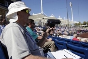 Mar 3, 2014; Phoenix, AZ, USA; A scout uses a radar gun during spring training between the Milwaukee Brewers and Chicago Cubs at Maryvale Baseball Park. Mandatory Credit: Rick Scuteri-USA TODAY Sports