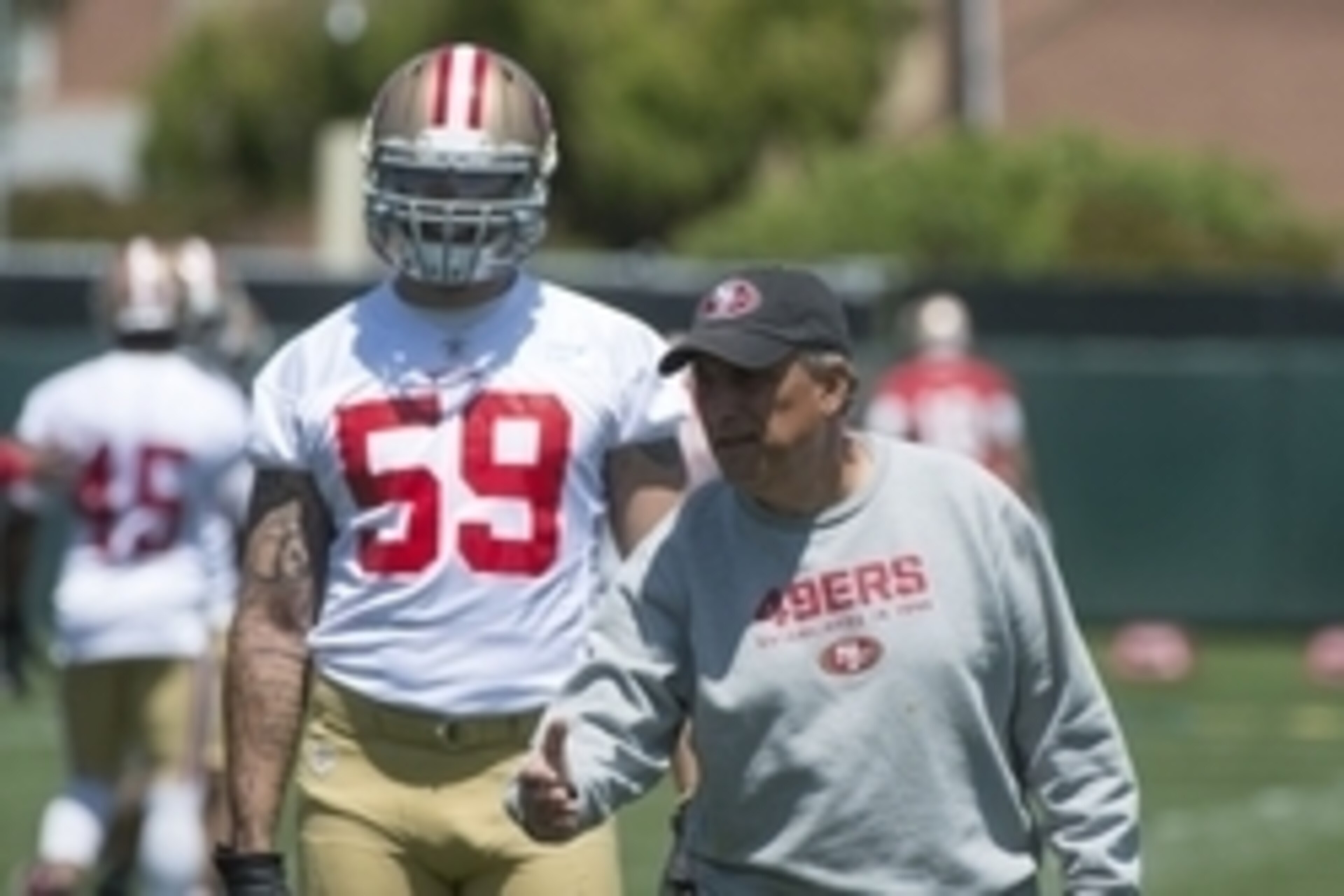 May 28, 2014; Santa Clara, CA, USA; San Francisco 49ers defensive coordinator Vic Fangio (right) instructs linebacker Aaron Lynch (59) during organized team activities at the SAP Performance Facility. Mandatory Credit: Kyle Terada-USA TODAY Sports