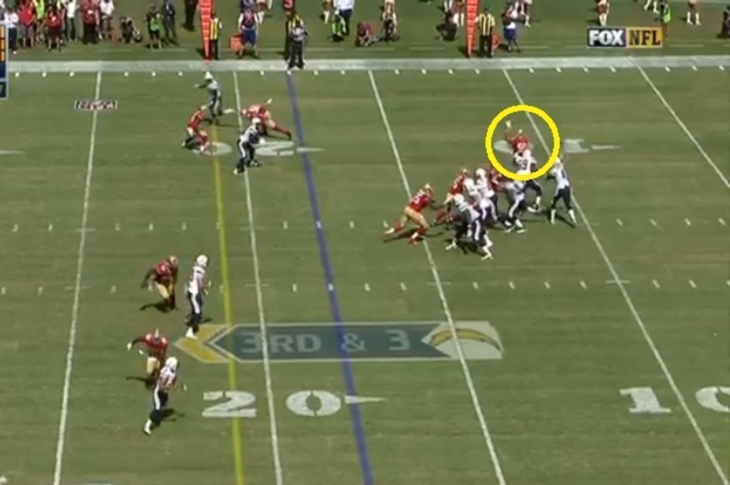 Lynch pressures San Diego's right tackle, which puts him in a position to defend the passing lane. He raises his arm and deflects the pass in the process.
