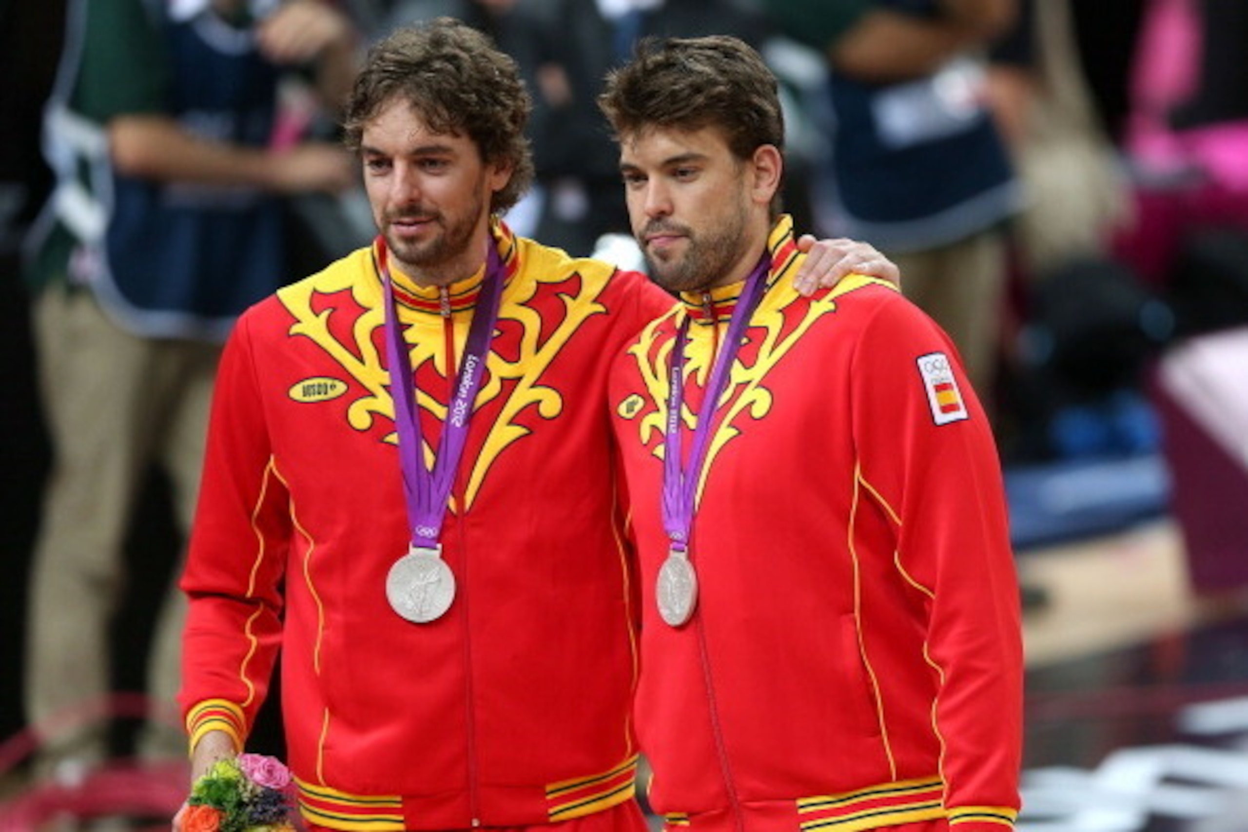 LONDON, ENGLAND - AUGUST 12:  Silver medallist Pau Gasol #4 of Spain and Marc Gasol #13 of Spain pose on the podium during the medal ceremony for the Men's Basketball on Day 16 of the London 2012 Olympics Games at North Greenwich Arena on August 12, 2012 