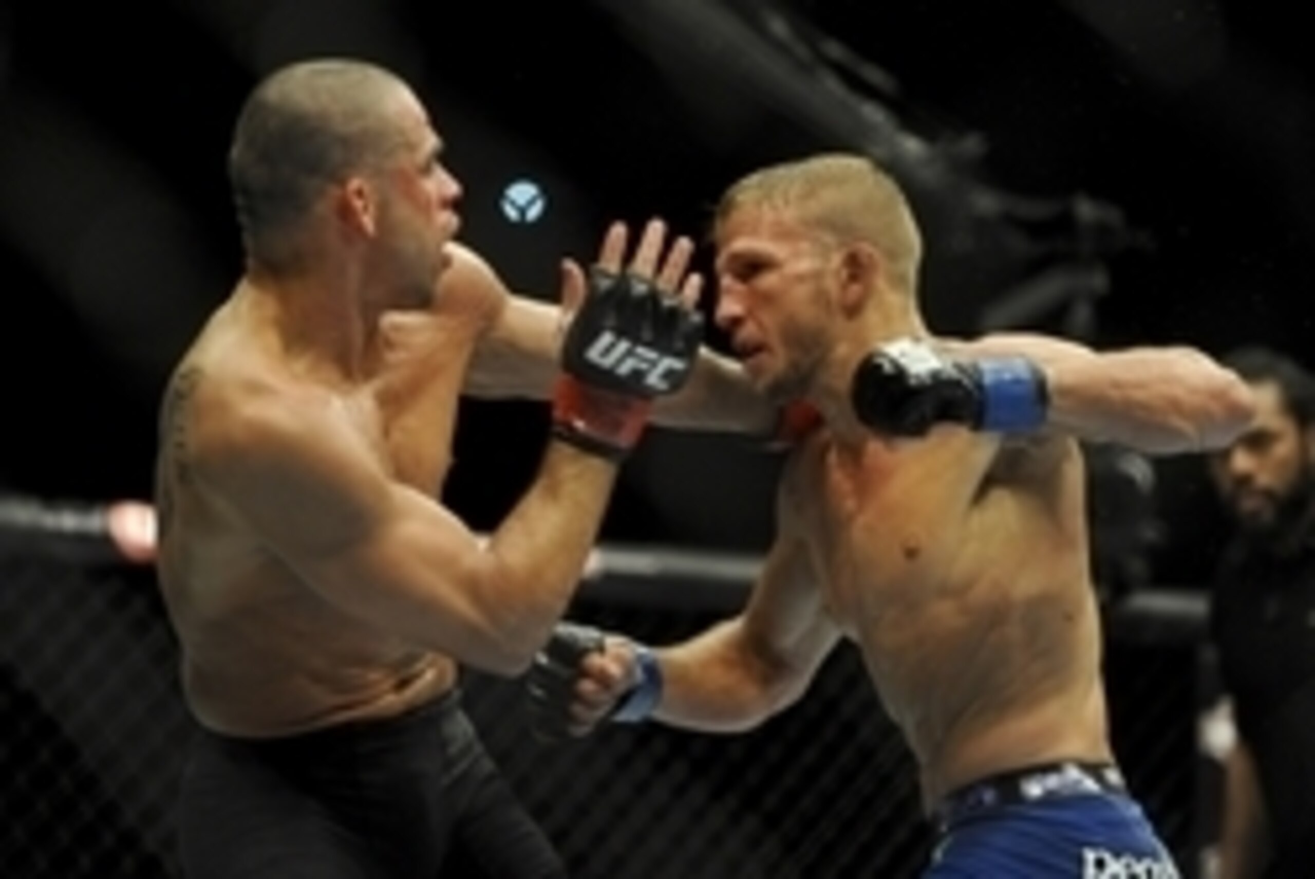 May 24, 2014; Las Vegas, NV, USA;   TJ Dillashaw (blue) throws a punch at  Renan Barao (red) during their UFC 173 bantamweight championship bout at MGM Grand Garden Arena. Dillashaw won the bout by way of TKO. Mandatory Credit: Stephen R. Sylvanie-USA TOD