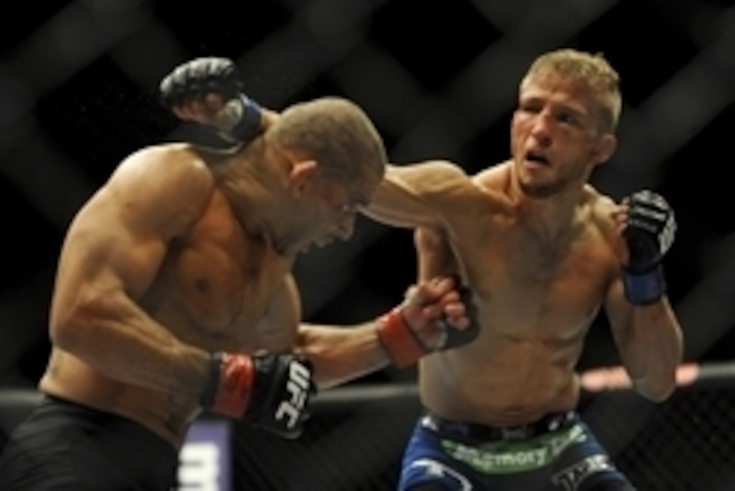 May 24, 2014; Las Vegas, NV, USA;  Renan Barao (red) dodges a punch from TJ Dillashaw (blue) during their UFC 173 bantamweight championship bout at MGM Grand Garden Arena. Dillashaw won the bout by way of TKO. Mandatory Credit: Stephen R. Sylvanie-USA TOD