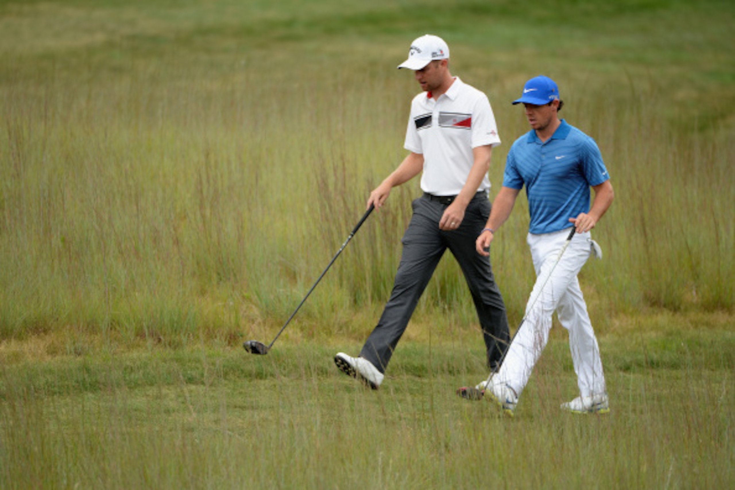 NORTON, MA - AUGUST 31:  Rory McIlroy of Northern Ireland and Chris Kirk walk off of the 13th hole during the third round of the Deutsche Bank Championship at the TPC Boston on August 31, 2014 in Norton, Massachusetts.  (Photo by Ross Kinnaird/Getty Image