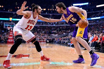Jan 20, 2014; Chicago, IL, USA; Los Angeles Lakers center Pau Gasol (16) dribbles the ball against Chicago Bulls center Joakim Noah (13) during the first half at United Center. Mandatory Credit: Mike DiNovo-USA TODAY Sports