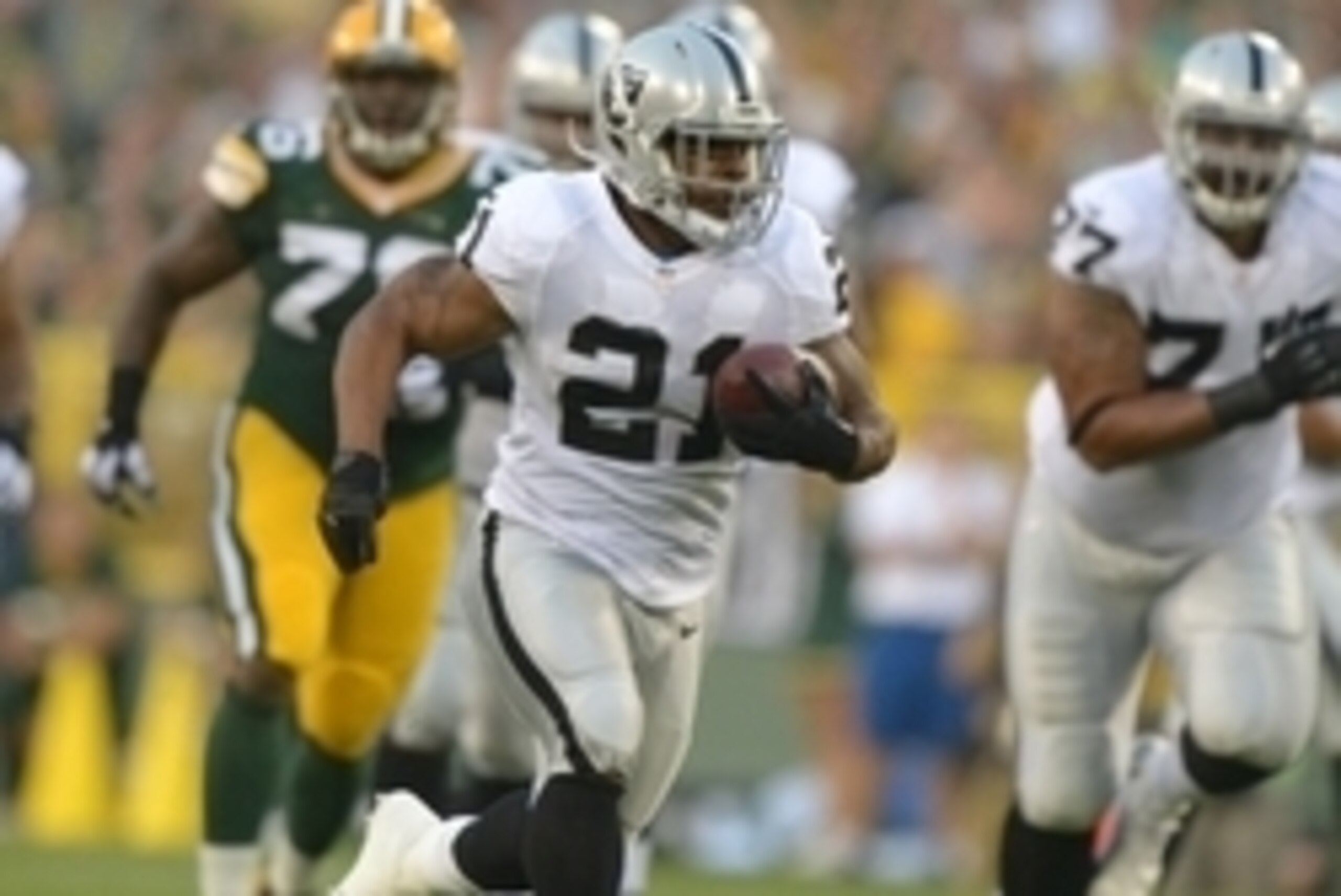 Aug 22, 2014; Green Bay, WI, USA; Oakland Raiders running back Maurice Jones-Drew (21) scores on a 40-yard touchdown run against the Green Bay Packers at Lambeau Field. Mandatory Credit: Kirby Lee-USA TODAY Sports