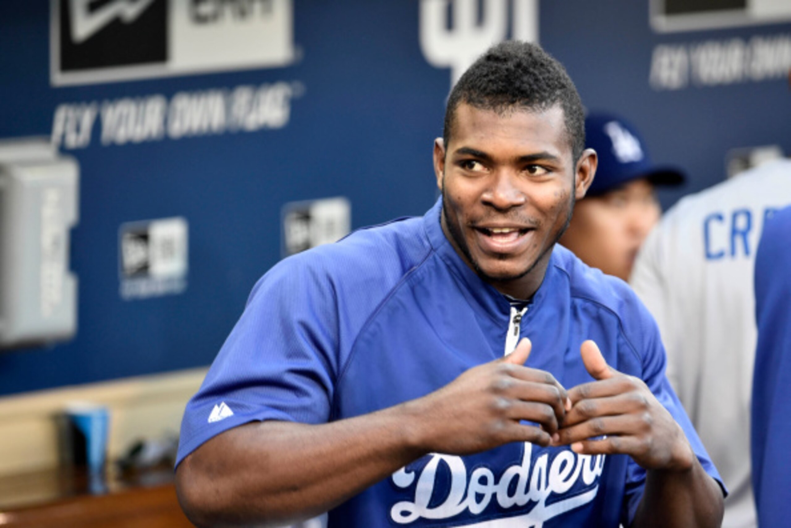 SAN DIEGO, CA - AUGUST 29:  Yasiel Puig #66 of the Los Angeles Dodgers looks out from the dugout before a baseball game against the San Diego Padres at Petco Park August, 29, 2014 in San Diego, California.  (Photo by Denis Poroy/Getty Images)