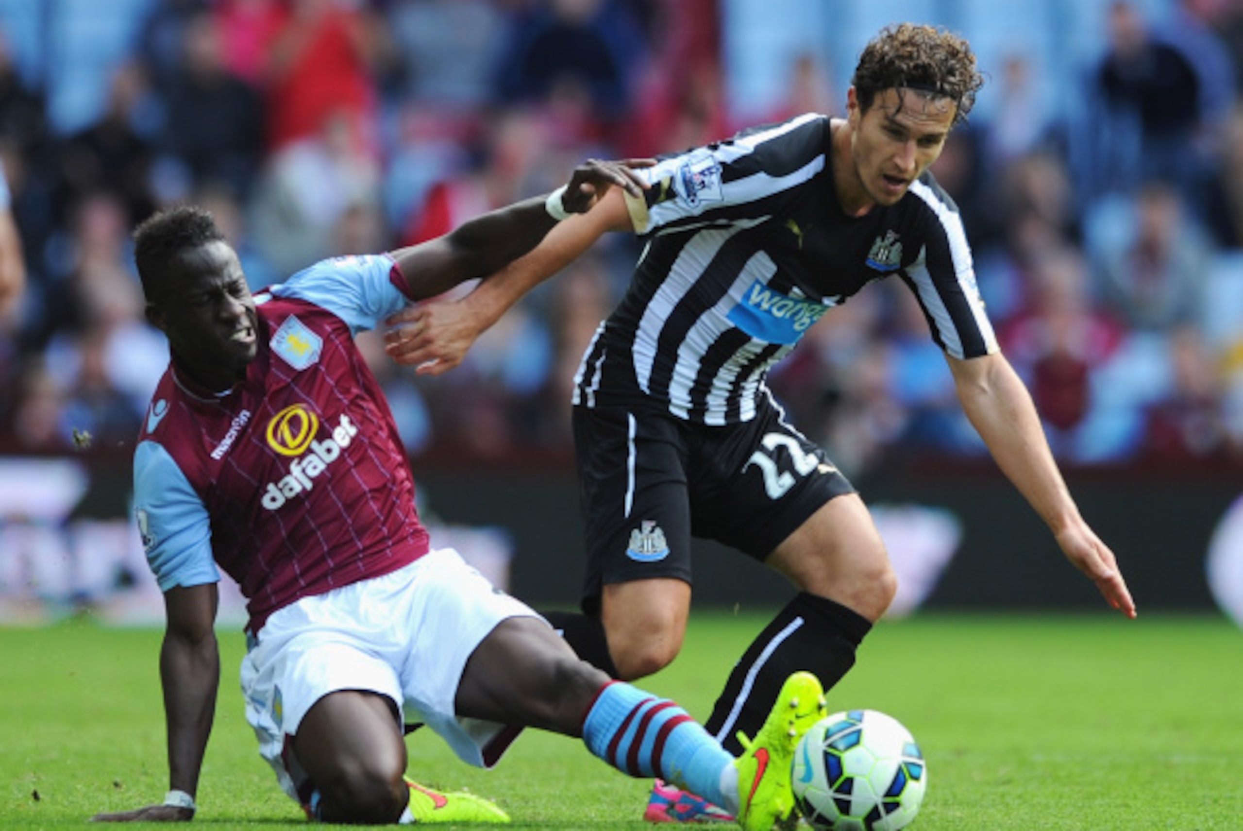 BIRMINGHAM, ENGLAND - AUGUST 23: Daryl Janmaat of Newcastle United is tackled by Aly Cissokho of Aston Villa during the Barclays Premier League match between Aston Villa and Newcastle United at Villa Park on August 23, 2014 in Birmingham, England. (Phot BIRMINGHAM, ENGLAND - AUGUST 23: Daryl Janmaat of Newcastle United is tackled by Aly Cissokho of Aston Villa during the Barclays Premier League match between Aston Villa and Newcastle United at Villa Park on August 23, 2014 in Birmingham, England. (Phot