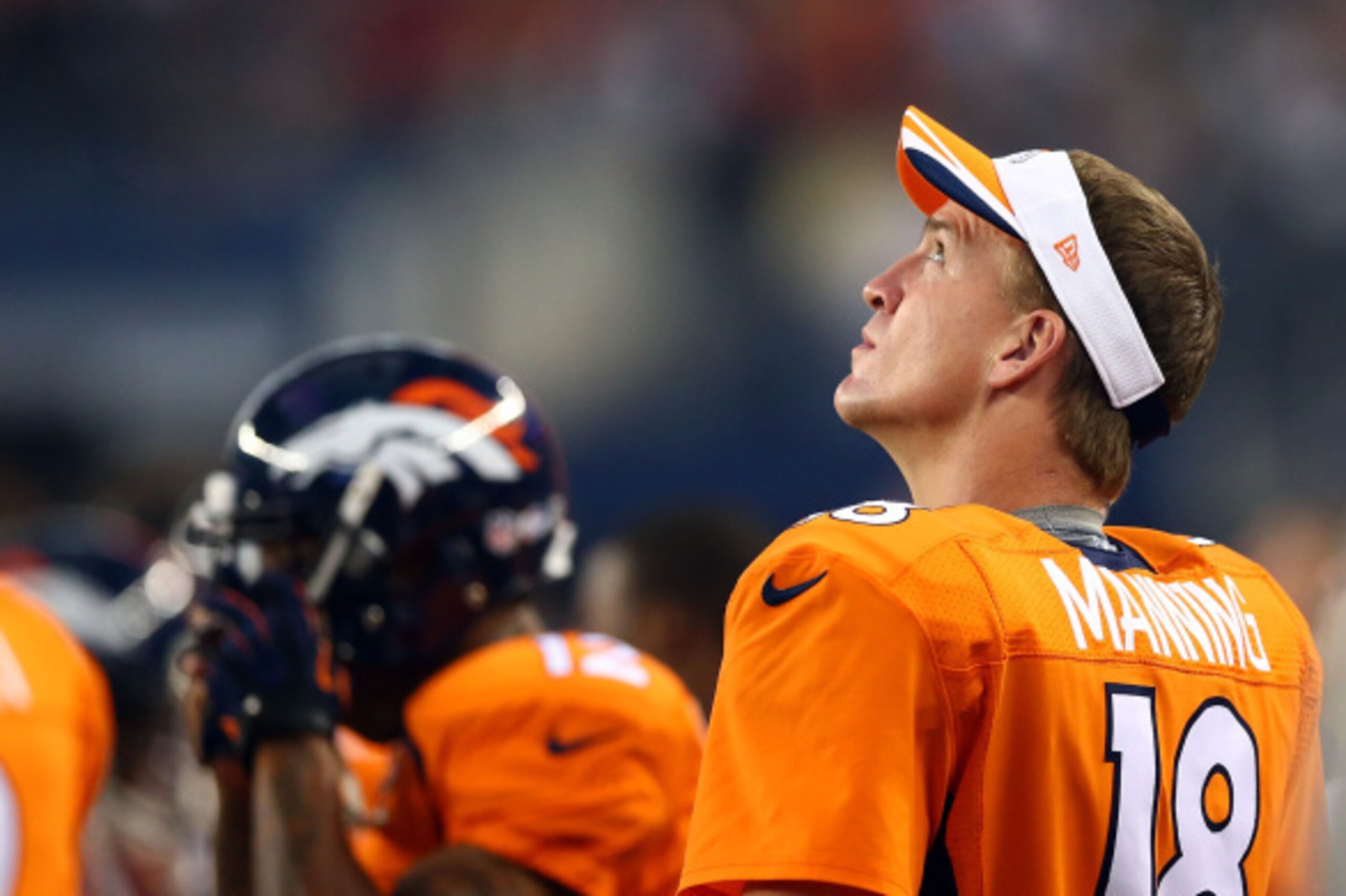 ARLINGTON, TX - AUGUST 28:  Peyton Manning #18 of the Denver Broncos watches from the sidelines against the Dallas Cowboys  in the first half of their preseason game at AT&T Stadium on August 28, 2014 in Arlington, Texas.  (Photo by Ronald Martinez/Getty 