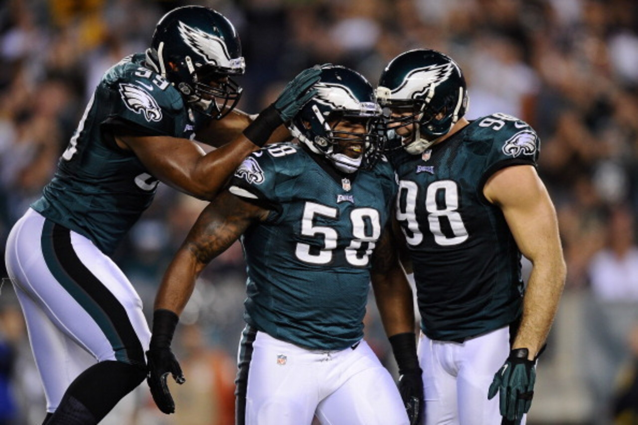PHILADELPHIA, PA - DECEMBER 22:  Trent Cole #58 celebrates with Connor Barwin #98 and DeMeco Ryans #59 of the Philadelphia Eagles after sacking Jay Cutler #6 of the Chicago Bears during the first quarter at Lincoln Financial Field on December 22, 2013 in 