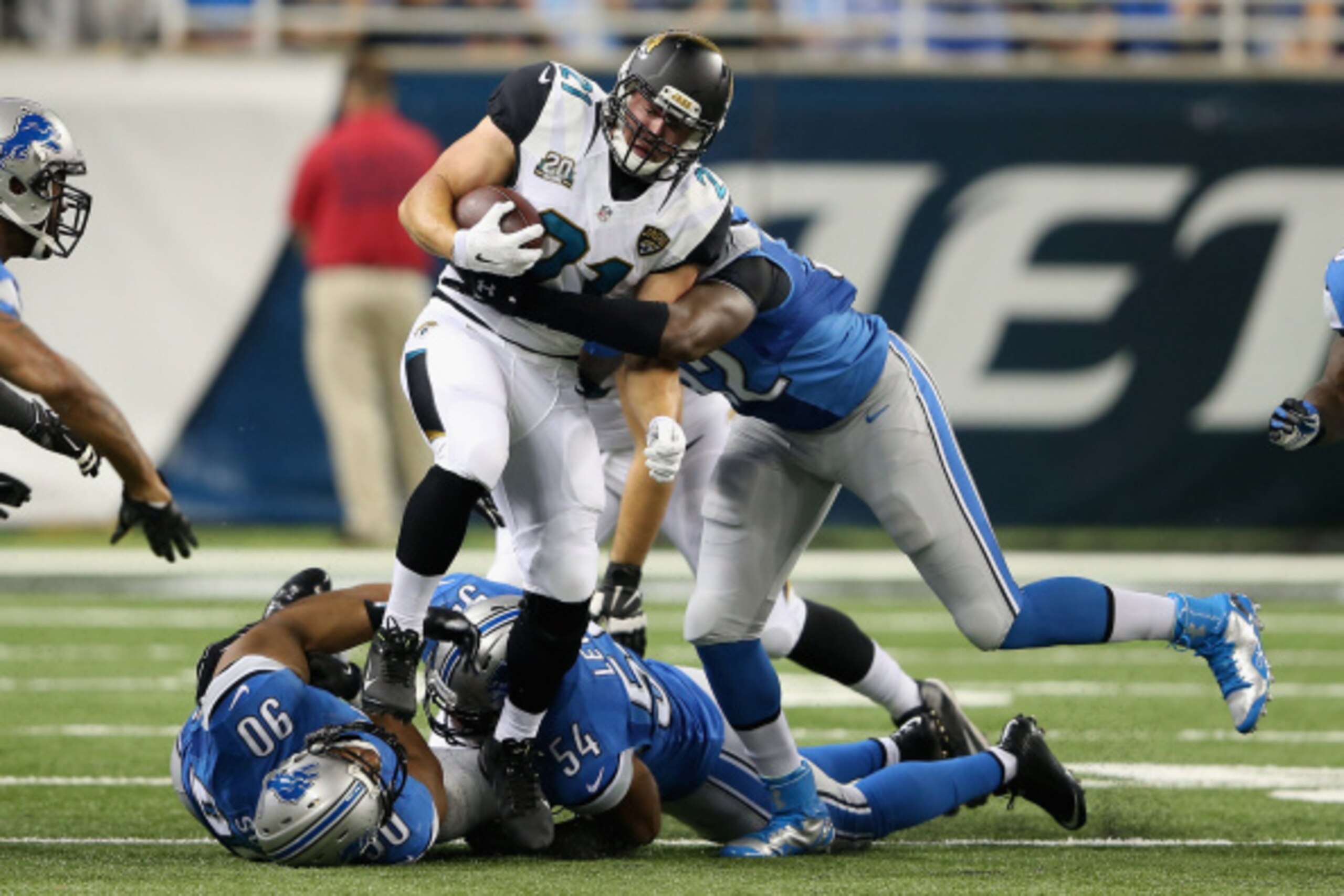 DETROIT, MI - AUGUST 22: Toby Gerhart #21 of the Jacksonville Jaguars tries to break the tackle by Devin Taylor #92 of the Detroit Lions in the first quarter during a preseason game at Ford Field on August 22, 2014 in Detroit, Michigan. (Photo by Leon Hal