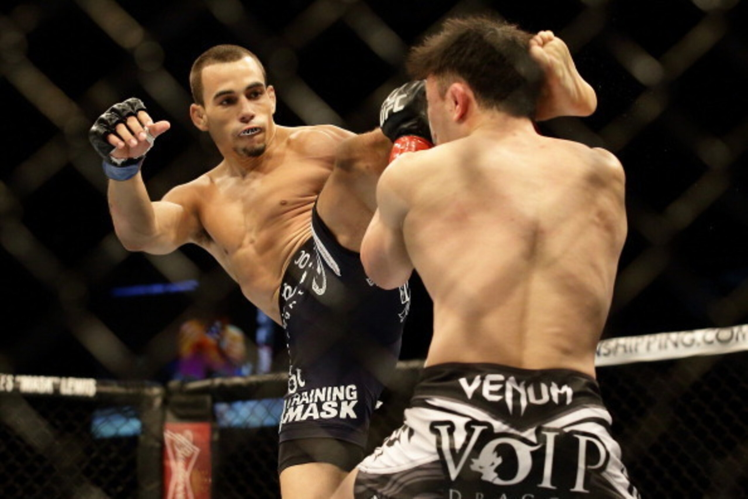 SINGAPORE - JANUARY 04: Sean Soriano  (L) kicks Tatsuya Kawajiri during  their UFC Fight Night Singapore featherweight bout at Marina Bay Sands on January 4, 2014 in Singapore.  (Photo by Suhaimi Abdullah/Getty Images)