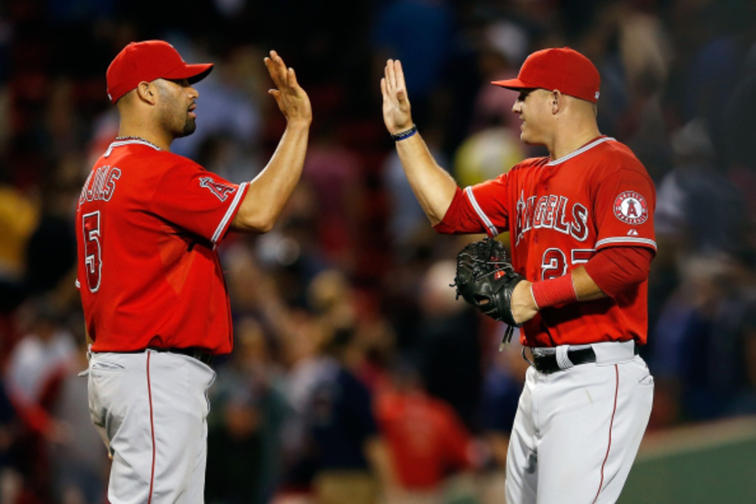 BOSTON, MA - AUGUST 18:  Albert Pujols #5 and Mike Trout #27 of the Los Angeles Angels celebrate a 4-2 win over the Boston Red Sox at Fenway Park on August 18, 2014 in Boston, Massachusetts.  (Photo by Jim Rogash/Getty Images)