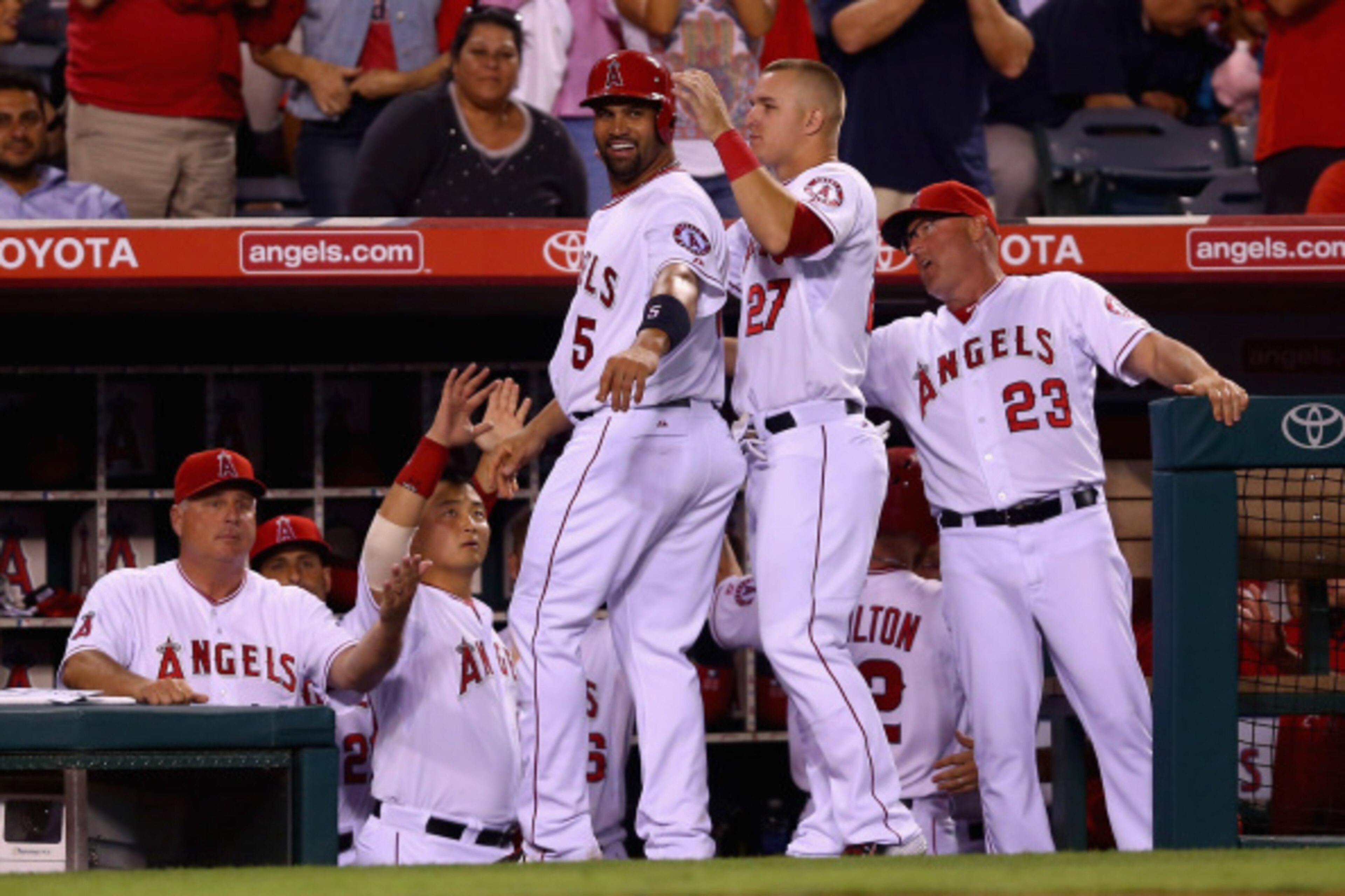 ANAHEIM, CA - AUGUST 13:  Albert Pujols #5 of the Los Angeles Angels of Anaheim celebrates with Mike Trout #27 after scoring a run against the Philadelphia Phillies in the sixth inning at Angel Stadium of Anaheim on August 13, 2014 in Anaheim, California.
