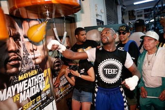 LAS VEGAS, NV - SEPTEMBER 02:  Boxer Floyd Mayweather Jr. (L) works out at the Mayweather Boxing Club on September 2, 2014 in Las Vegas, Nevada. Mayweather Jr. will defend his WBC/WBA welterweight titles against Marcos Maidana on September 13 in Las Vegas
