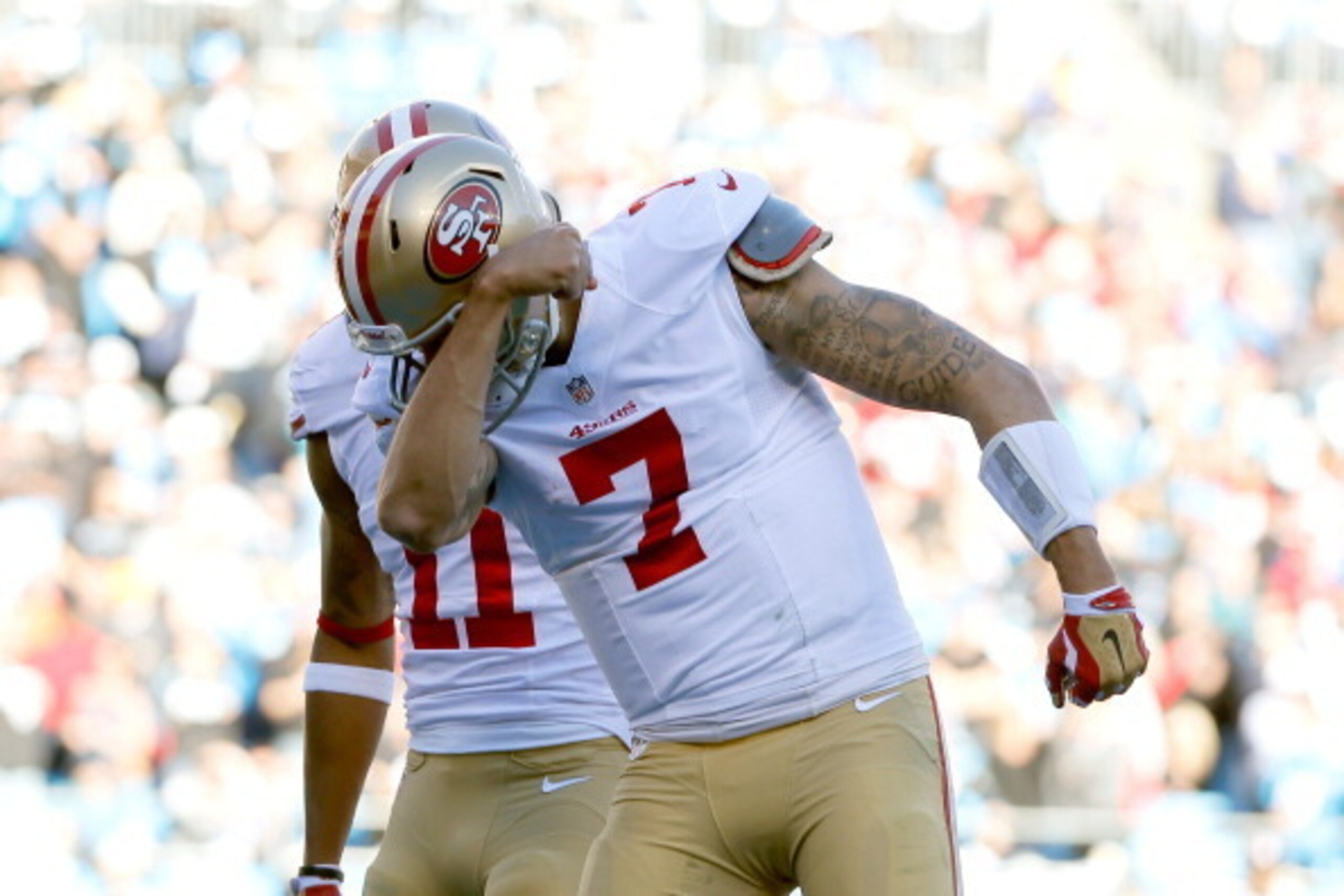 CHARLOTTE, NC - JANUARY 12:  Colin Kaepernick #7 of the San Francisco 49ers celebrates after a touchdown in the third quarter against the Carolina Panthers during the NFC Divisional Playoff Game at Bank of America Stadium on January 12, 2014 in Charlotte,