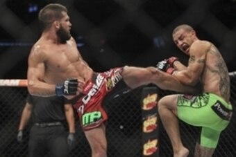 Jun 28, 2014; San Antonio, TX, USA; Cub Swanson (red gloves) fights Jeremy Stephens (blue gloves) in a Featherweight bout at UFC Fight Night 43 at AT&T Center. Mandatory Credit: Troy Taormina-USA TODAY Sports