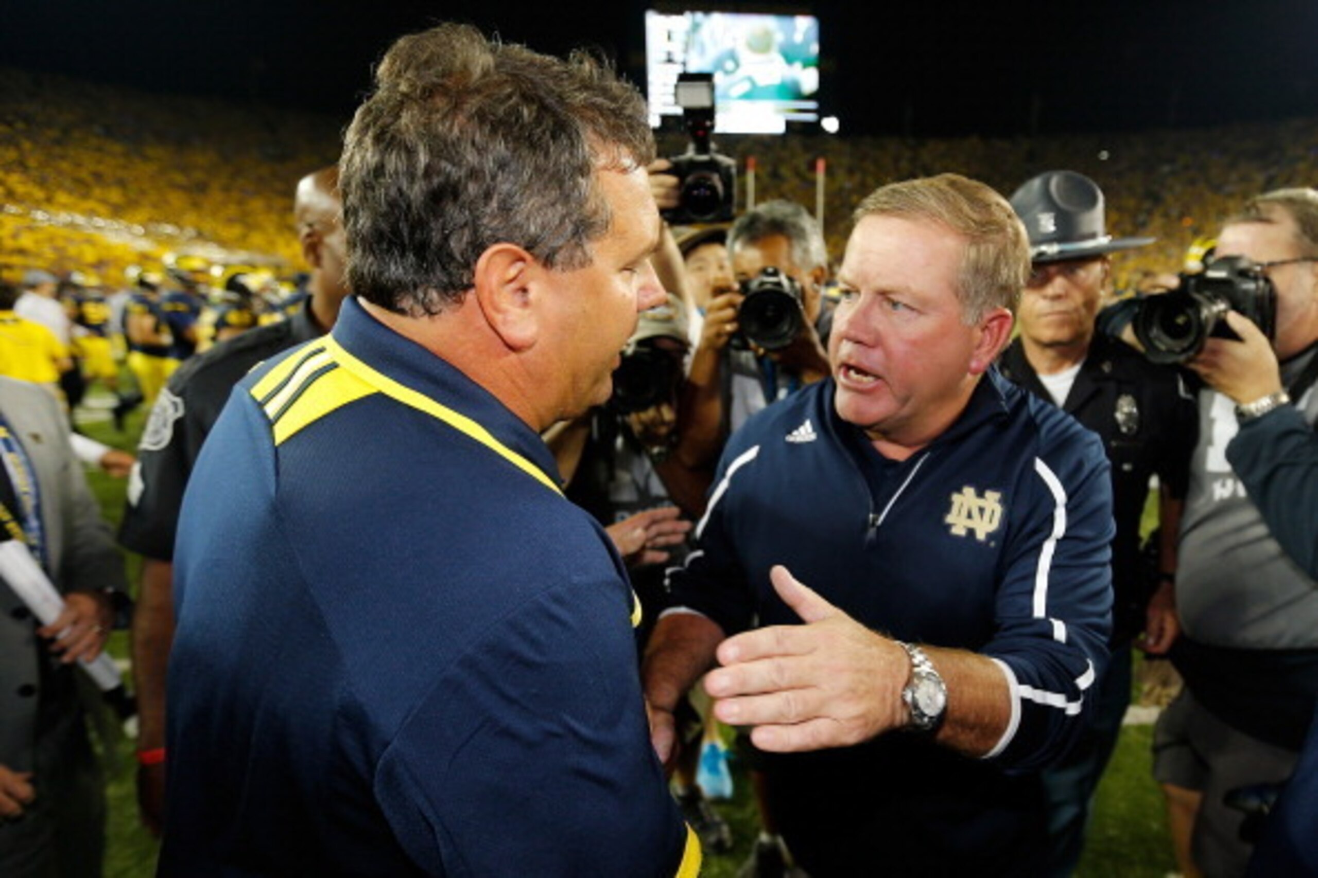 ANN ARBOR, MI - SEPTEMBER 07: Head coach Brian Kelly of the Notre Dame Fighting Irish shakes hands with head coach Brady Hoke after a 41-30 loss at Michigan Stadium on September 7, 2013 in Ann Arbor, Michigan.  (Photo by Gregory Shamus/Getty Images)