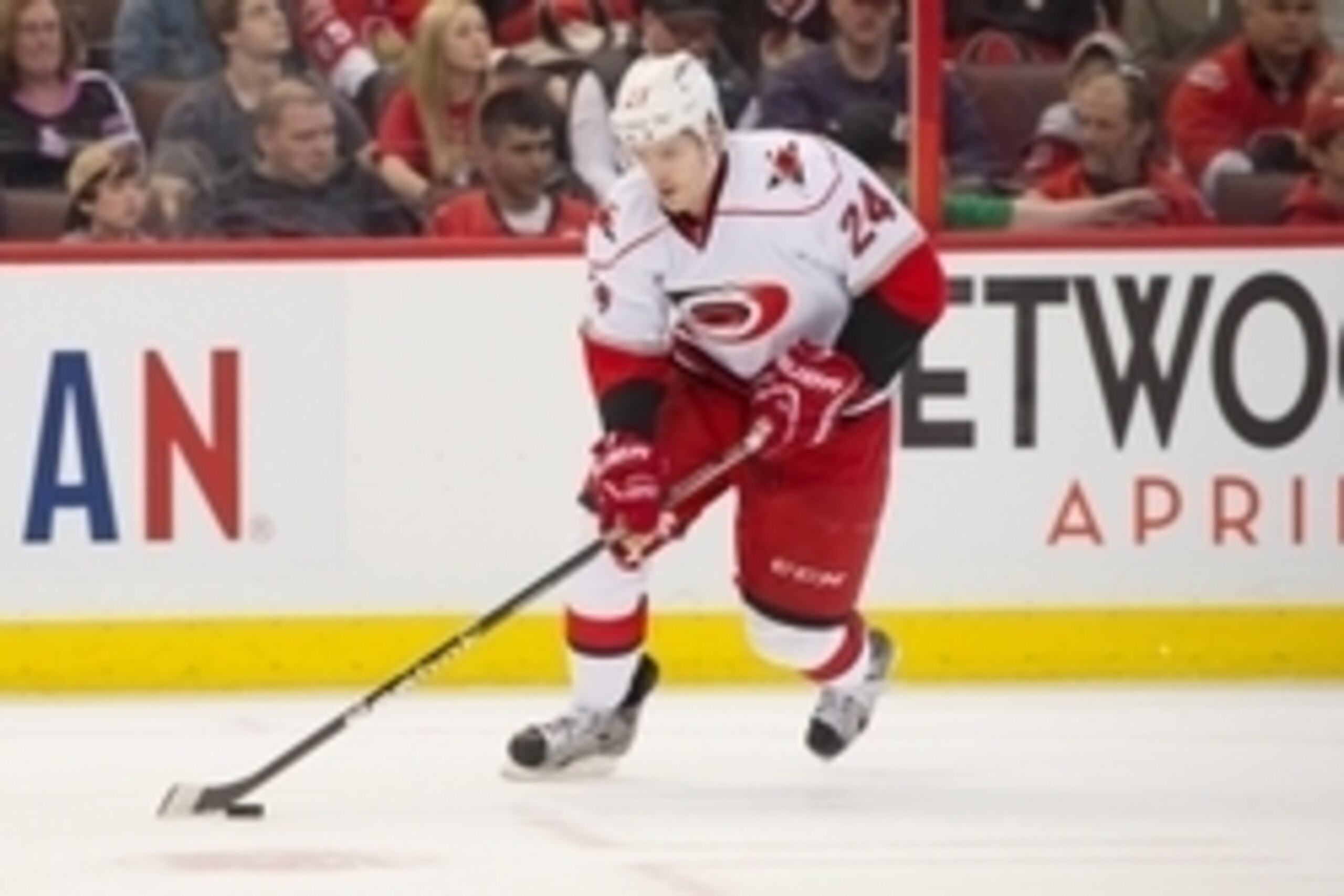 Apr 16, 2013; Ottawa, ON, CAN; Carolina Hurricanes defenseman Bobby Sanguinetti (24) controls the puck in the second period against the Ottawa Senators at Scotiabank Place. Mandatory Credit: Marc DesRosiers-USA TODAY Sports