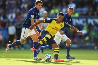 LEICESTER, ENGLAND - AUGUST 31:  Alex Oxlade-Chamberlain of Arsenal takes on Dean Hammond and Paul Konchesky of Leicester City during the Barclays Premier League match between Leicester City and Arsenal at The King Power Stadium on August 31, 2014 in Leic