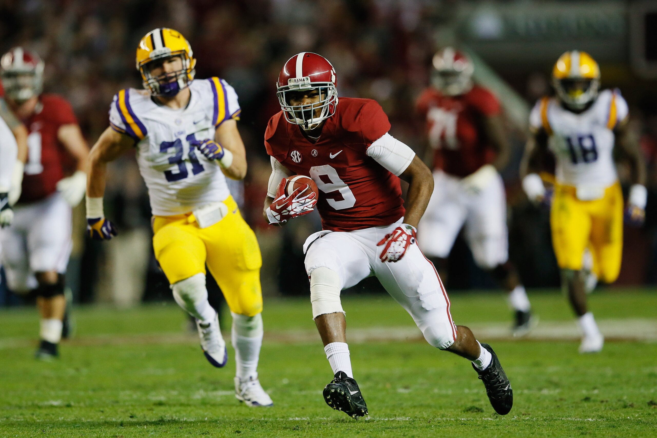 TUSCALOOSA, AL - NOVEMBER 09:  Amari Cooper #9 of the Alabama Crimson Tide runs the ball against D.J. Welter #31 of the LSU Tigers Tide during the first half of the game at Bryant-Denny Stadium on November 9, 2013 in Tuscaloosa, Alabama.  (Photo by Kevin