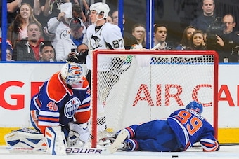 EDMONTON, AB - JANUARY 10:  Devan Dubnyk #40 and Sam Gagner #89 of the Edmonton Oilers react in front of their net after being scored on by Sidney Crosby #87 of the Pittsburgh Penguins during an NHL game at Rexall Place on January 10, 2014 in Edmonton, Al