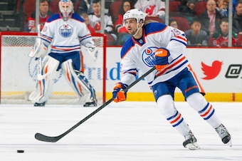 NEWARK, NJ - FEBRUARY 07: Justin Schultz #19 of the Edmonton Oilers playing in his 100th career NHL game controls the puck against the New Jersey Devils at the Prudential Center on February 7, 2014 in Newark, New Jersey. (Photo by Andy Marlin/NHLI via Get