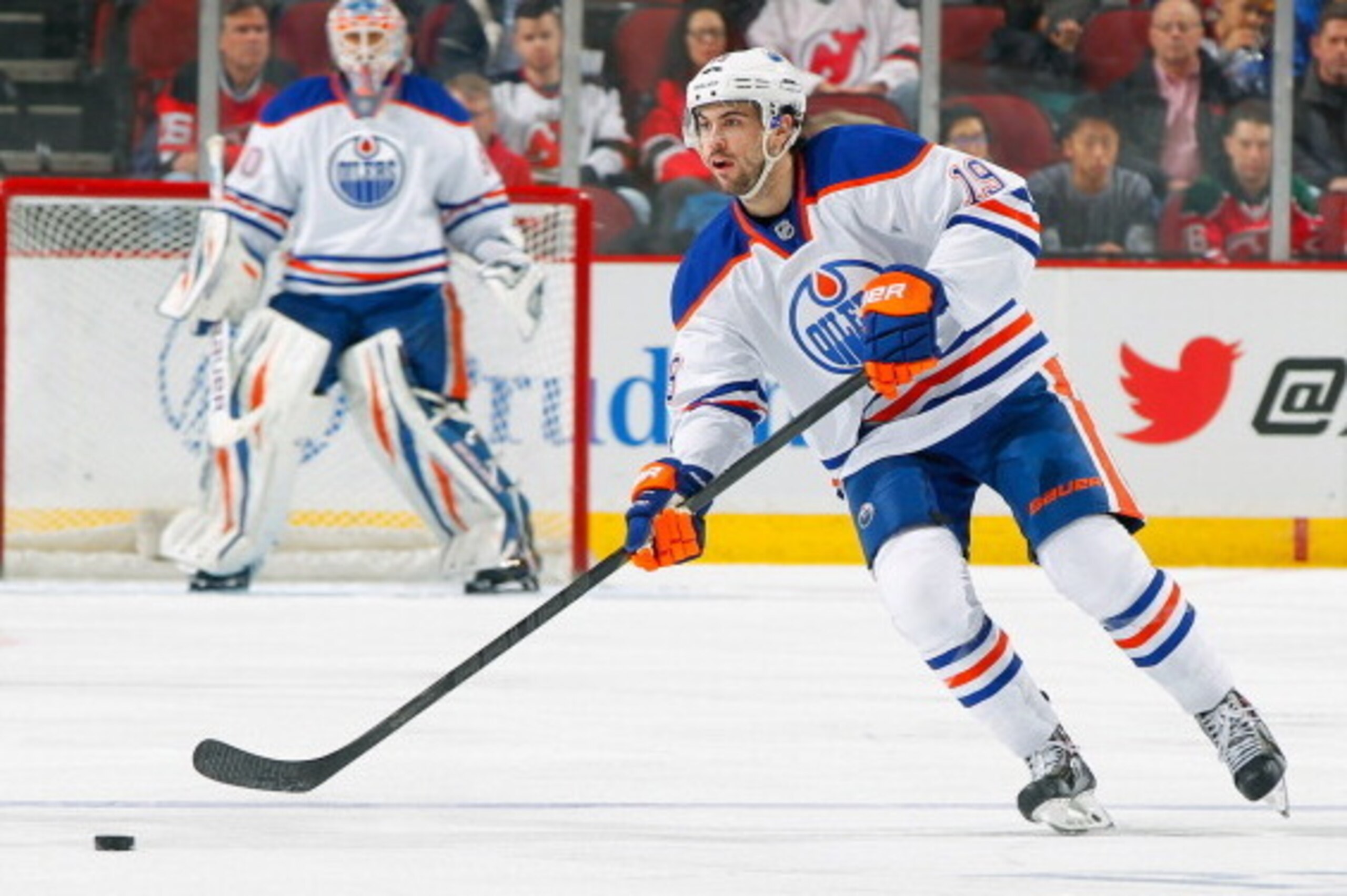 NEWARK, NJ - FEBRUARY 07: Justin Schultz #19 of the Edmonton Oilers playing in his 100th career NHL game controls the puck against the New Jersey Devils at the Prudential Center on February 7, 2014 in Newark, New Jersey. (Photo by Andy Marlin/NHLI via Get