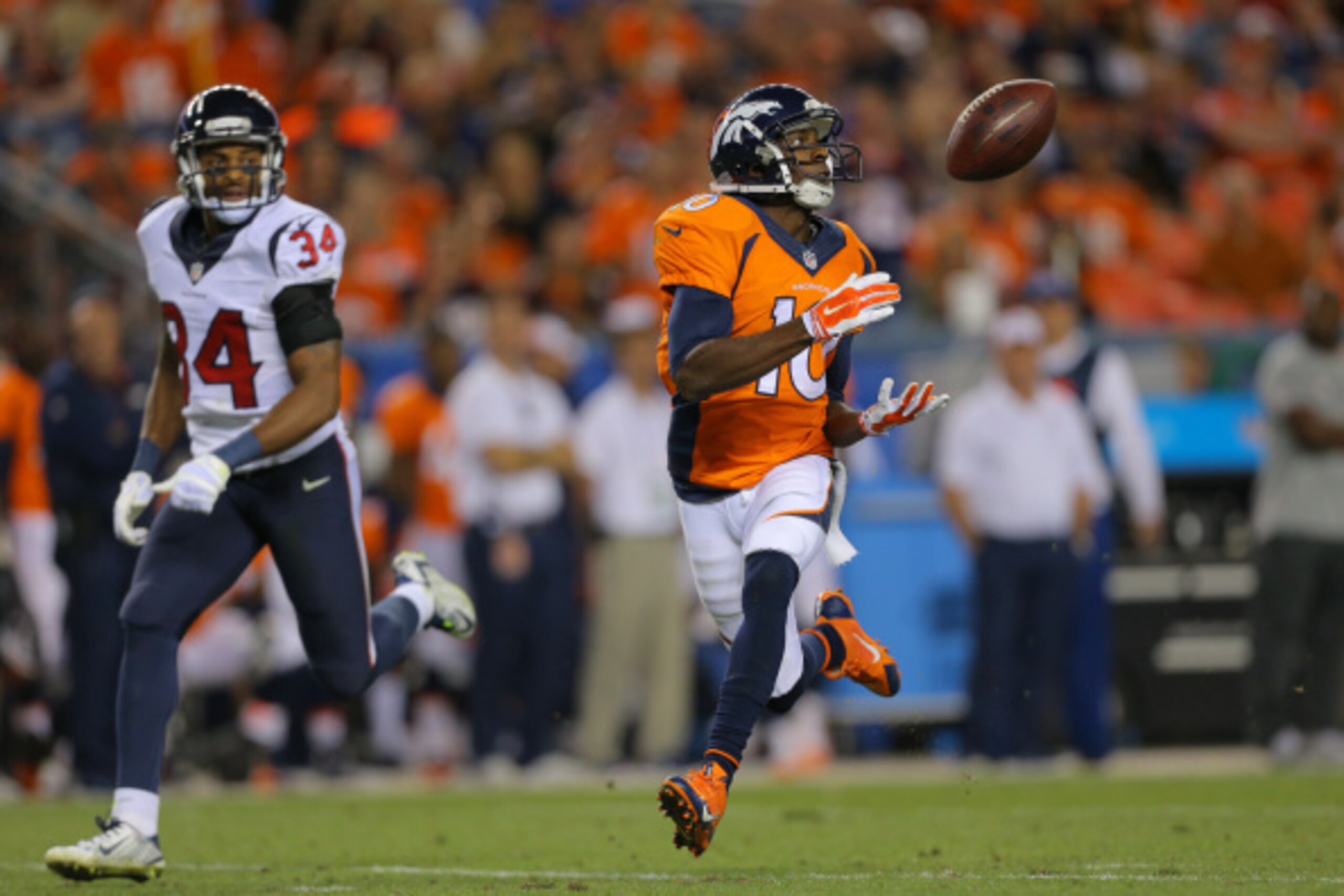 DENVER, CO - AUGUST 23:  Wide receiver Emmanuel Sanders #10 of the Denver Broncos catches a pass for a 67 yard touchdown in front of cornerback A.J. Bouye #34 of the Houston Texans during a preseason game at Sports Authority Field at Mile High on August 2